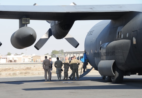 737th Expeditionary Airlift Wing Airmen escort personnel onto a C-130H Hercules at an undisclosed location in Southwest Asia Feb. 8, 2017. These Airmen are deployed from the 182nd Airlift Wing, Illinois Air National Guard, in support of Operation Inherent Resolve. (U.S. Air Force photo/Tech. Sgt. Kenneth McCann)