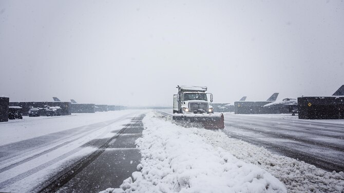 Members of the 455th Expeditionary Civil Engineer Squadron plow the fighter ramp at Bagram Airfield, Afghanistan Feb. 4, 2017. The 455th ECES is responsible for maintaining the airfield to ensure flight operations can continue. (U.S. Air Force photo by Staff Sgt. Katherine Spessa)