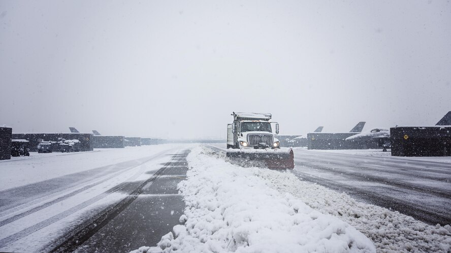Members of the 455th Expeditionary Civil Engineer Squadron plow the fighter ramp at Bagram Airfield, Afghanistan Feb. 4, 2017. The 455th ECES is responsible for maintaining the airfield to ensure flight operations can continue. (U.S. Air Force photo by Staff Sgt. Katherine Spessa)