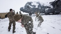 Members of the 455th Expeditionary Aircraft Maintenance Squadron EC-130 Compass Call Aircraft Maintenance Unit have a snowball fight after shoveling snow from under their aircraft at Bagram Airfield, Afghanistan Feb. 4, 2017. The unit ensured their aircraft were cleared of snow to return to the mission after the base got several inches of snowfall. (U.S. Air Force photo by Staff Sgt. Katherine Spessa)