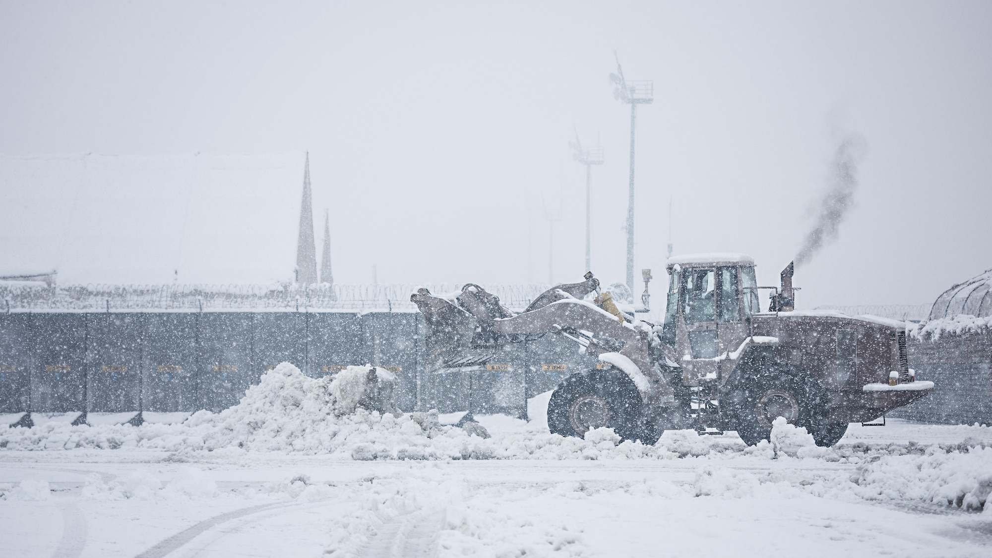 The 455th Expeditionary Civil Engineer Squadron plow the fighter ramp at Bagram Airfield, Afghanistan Feb. 4, 2017. The 455th Expeditionary Aircraft Maintenance Squadrons and ECES de-iced aircraft and cleared snow from the runway so the F-16 Fighting Falcons of the 79th Expeditionary Fighter Squadron could continue their missions - flying multiple sorties daily to support the 455th Air Expeditionary Wing’s mission to defend, support and deliver airpower. (U.S. Air Force photo by Staff Sgt. Katherine Spessa)