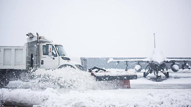 Members of the 455th Expeditionary Civil Engineer Squadron plow the fighter ramp at Bagram Airfield, Afghanistan Feb. 4, 2017. The 455th ECES quickly cleared the ramp so the 79th Expeditionary Fighter Squadron could continue to provide counterterrorism to enable a successful train, advise, assist campaign. (U.S. Air Force photo by Staff Sgt. Katherine Spessa)