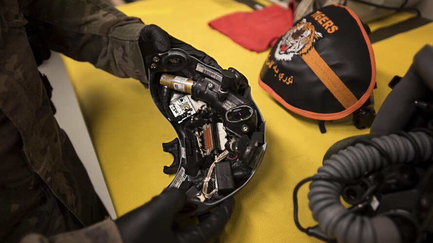 Airman 1st Class Louis Mendoza, 455th Expeditionary Operations Support Squadron aircrew flight equipment journeyman, inspects a pilot’s helmet Feb. 2, 2017 at the 79th Expeditionary Fighter Squadron operations building at Bagram Airfield, Afghanistan. AFE technicians assigned to the fighter squadron are responsible for all of a pilot's flight equipment such as helmet, oxygen mask, harness and all life-saving equipment. (U.S. Air Force photo by Staff Sgt. Katherine Spessa)