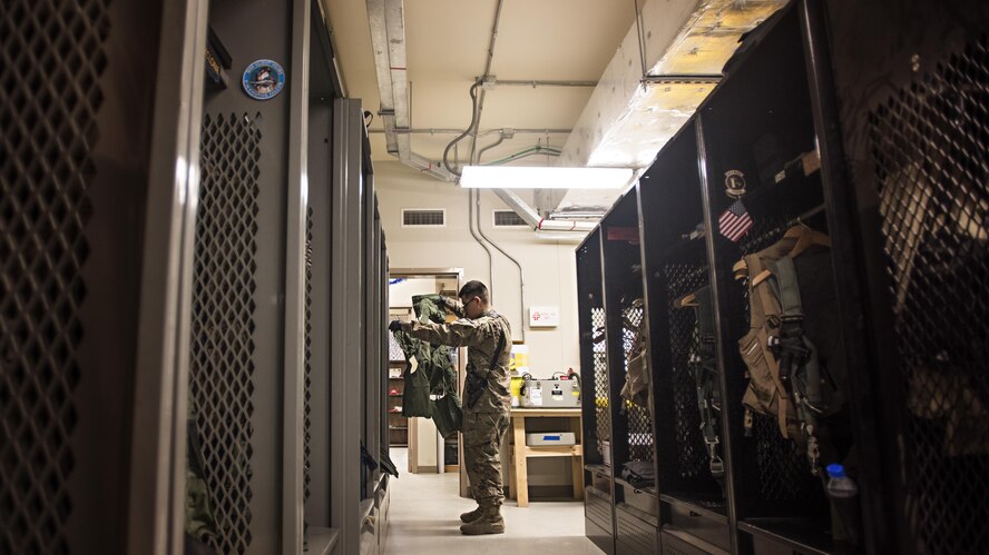 Airman 1st Class Louis Mendoza, 455th Expeditionary Operations Support Squadron aircrew flight equipment journeyman, inspects a pilot’s G-Suit Feb. 2, 2017 at the 79th Expeditionary Fighter Squadron operations building at Bagram Airfield, Afghanistan. Part of preparing a plane for flight is making sure it's equipped with supplies for any situation. Responsible for ensuring that all flight and safety equipment is in perfect working order, AFE specialists make sure Airmen have the supplies necessary. (U.S. Air Force photo by Staff Sgt. Katherine Spessa)