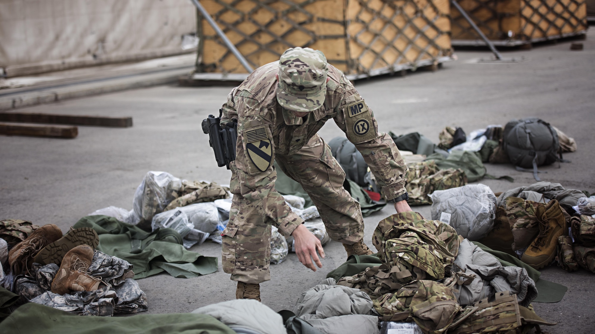 Army Spc. Ian Rode Basto, 368th Military Police Company customs agent, inspects equipment being shipped to the U.S. Feb. 14, 2017 at Hamid Karzai International Airport, Kabul. CMRE air transporters conduct joint inspections with customs agents before material is sent back to the United States. (U.S. Air Force photo by Staff Sgt. Katherine Spessa)