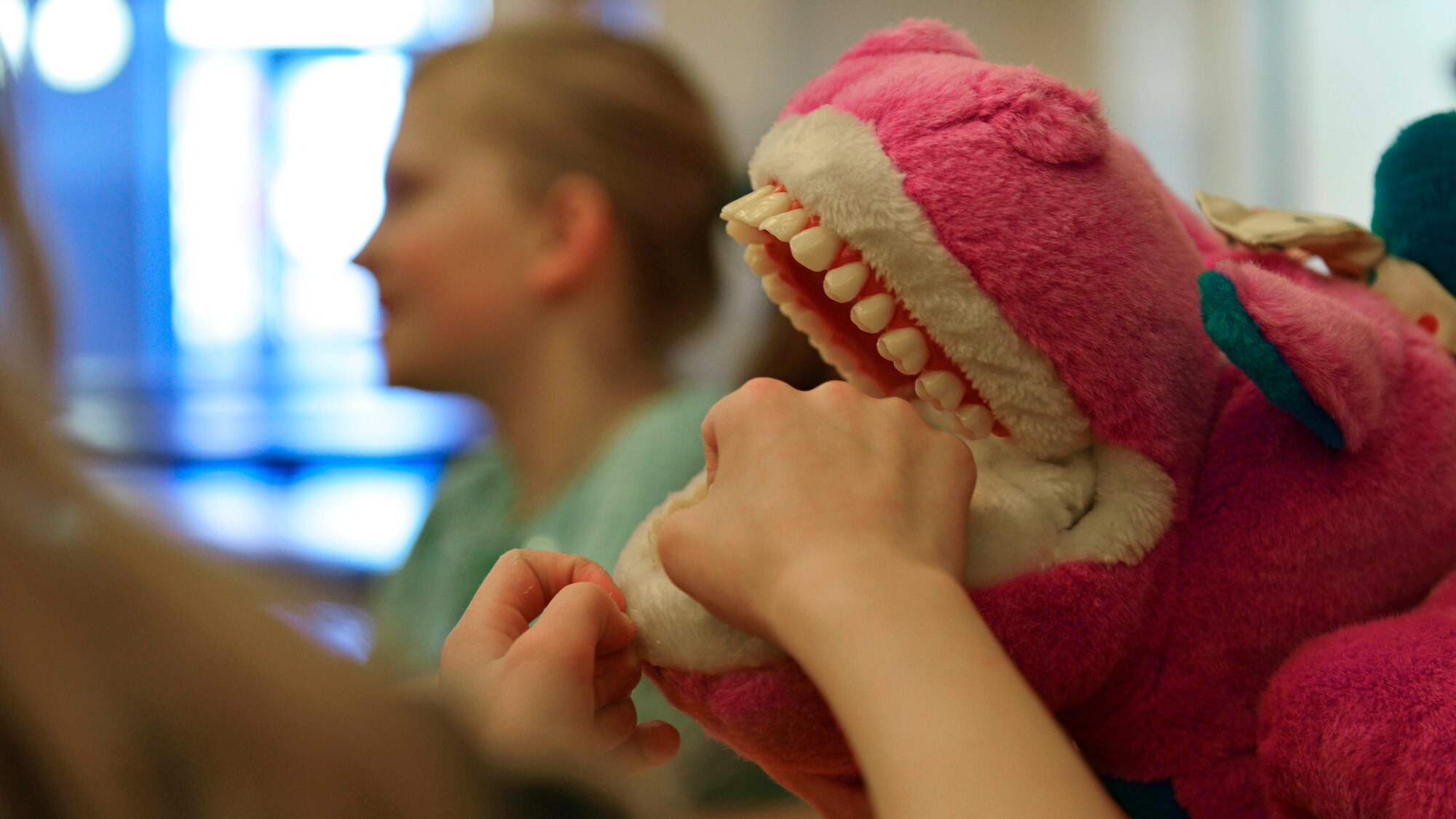 A child practices flossing during a Children’s Dental Health Month event, Feb. 15, 2017, at Aviano Air Base, Italy. Airmen from the 31st Dental Squadron educated children on the importance of healthy eating and proper brushing and flossing techniques. (U.S. Air Force photo by Senior Airman Cary Smith)
