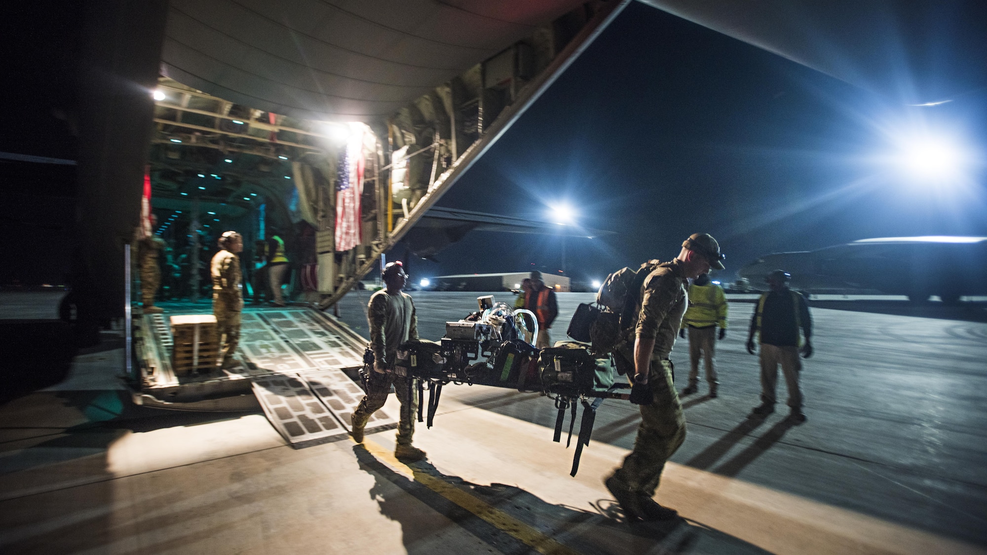 Staff Sgt. Errington Neysmith and Senior Airman Joshua O'Sullivan, 455th Expeditionary Aeromedical Evacuation Squadron duty controller and Critical Care Air Transport Team respiratory therapist, respectively, carry respirator equipment when picking up a patient from the Kandahar Regional Military Hospital, Kandahar Airfield, Afghanistan Feb. 22, 2017. The patient was an Afghan National Army soldier who suffered injuries during a battle. The CCATT brought him to the Craig Joint Theater Hospital, Bagram Airfield, Afghanistan to receive treatment. (U.S. Air Force photo by Staff Sgt. Katherine Spessa)