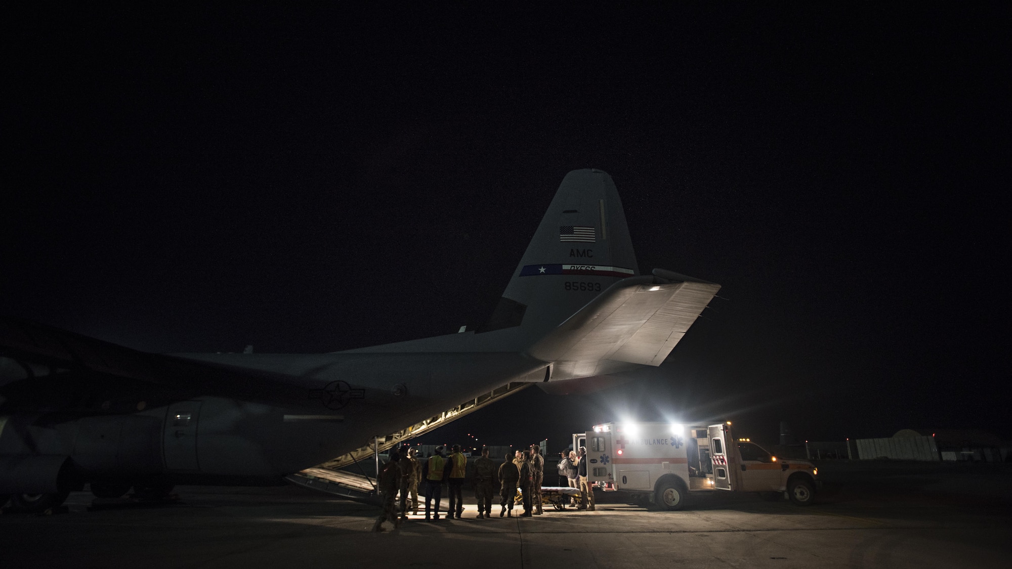 Members of the 455th Expeditionary Aeromedical Evacuation Squadron carry a patient from a C-130J Hercules to a waiting ambulance at Bagram Airfield, Afghanistan, Feb. 22, 2017. Patients are at their most vulnerable while being transported, so aeromedical evacuation technicians are trained in providing continuous stabilization, advanced care and life-saving intervention techniques in flight. (U.S. Air Force photo by Staff Sgt. Katherine Spessa)