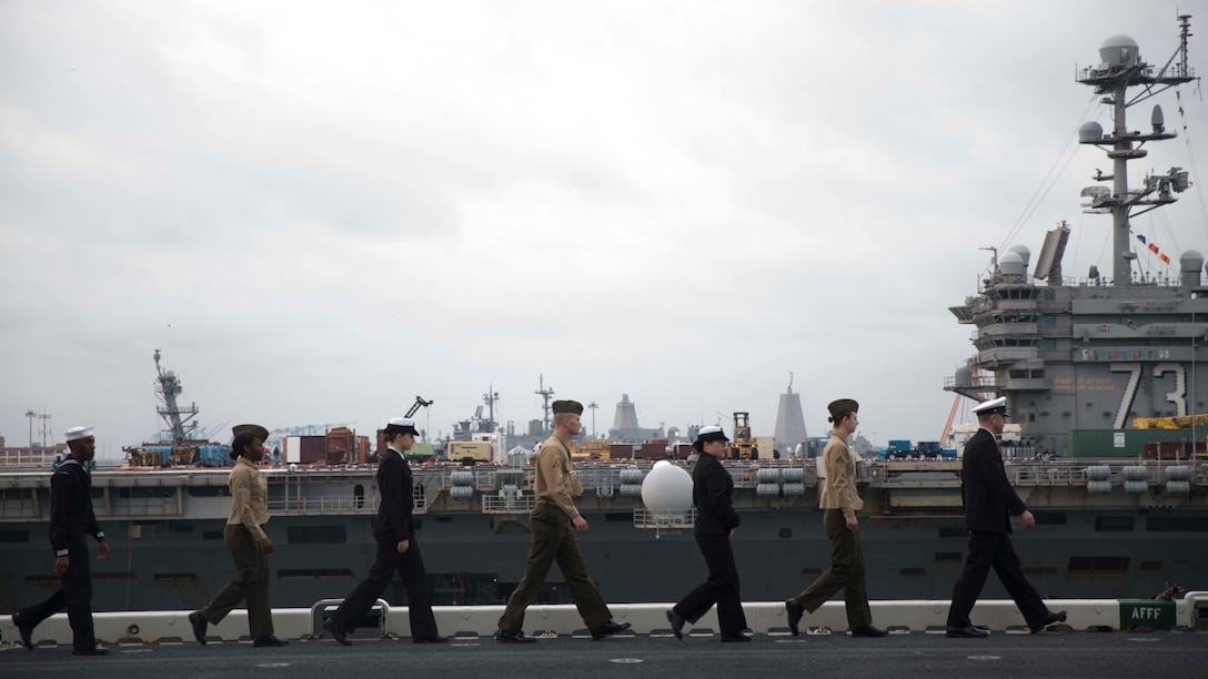 Marines and Sailors with the 24th Marine Expeditionary Unit man the rails as amphibious assault ship USS Bataan (LHD 5) prepares to go underway for deployment March 1, 2017. The 24th MEU will operate in Europe and the Middle East in the coming months providing crisis response and contingency support for combatant commanders, including maritime security operations, humanitarian assistance, and advance force operations.
