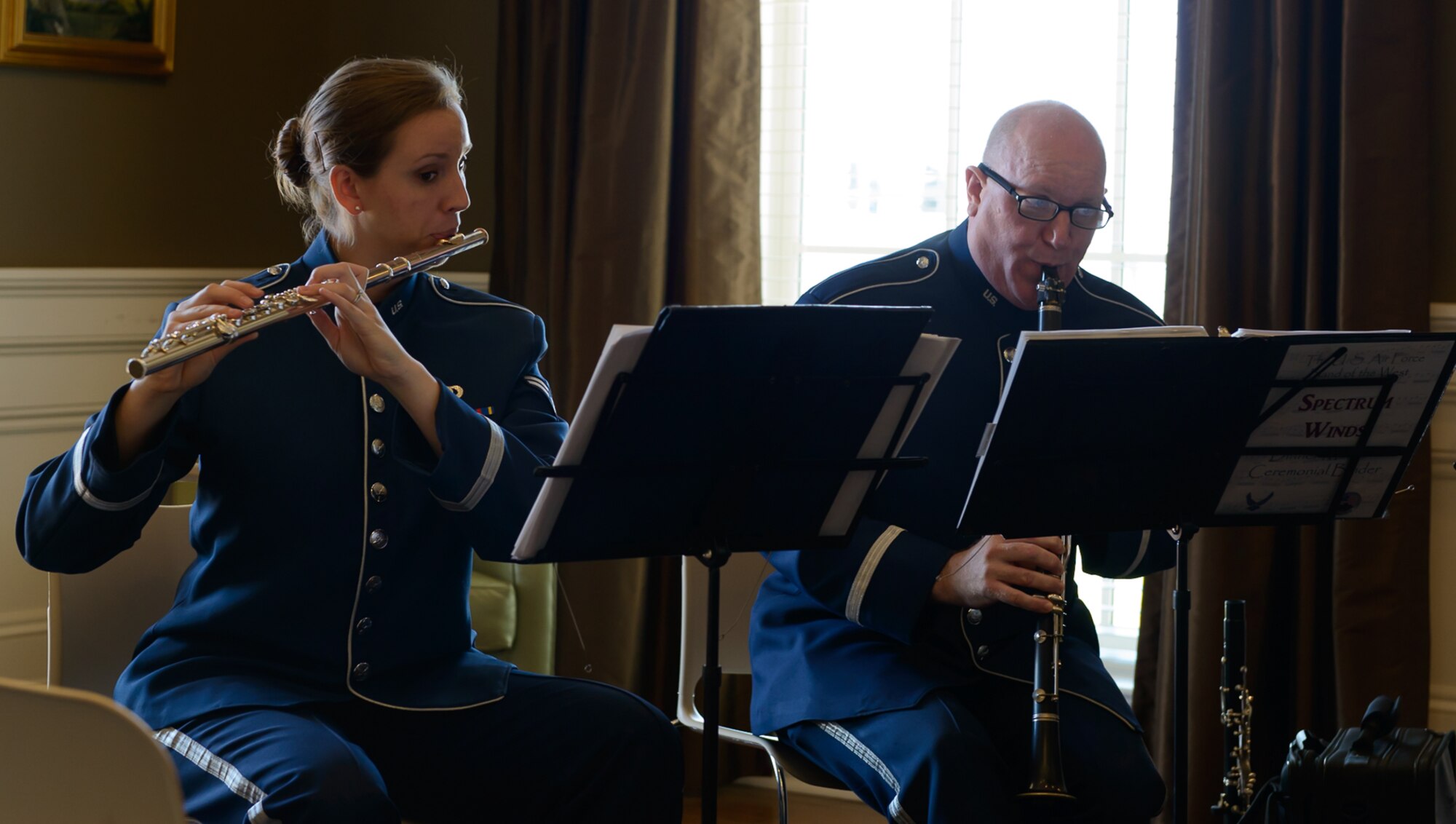 Airman 1st Class Elizabeth Robinson, Band of the West flautist, and Master Sgt. Mark Craig, Band of the West clarinetist, preform for Gulf Coast residents and travelers at the Biloxi Visitor's Center Feb. 26, 2017 Biloxi, Miss. Members of the Spectrum Winds Quintet, an ensemble of the Band of the West, played a medley of concert and ceremonial marching music for the attendees. (U.S. Air Force photo by Andre' Askew)