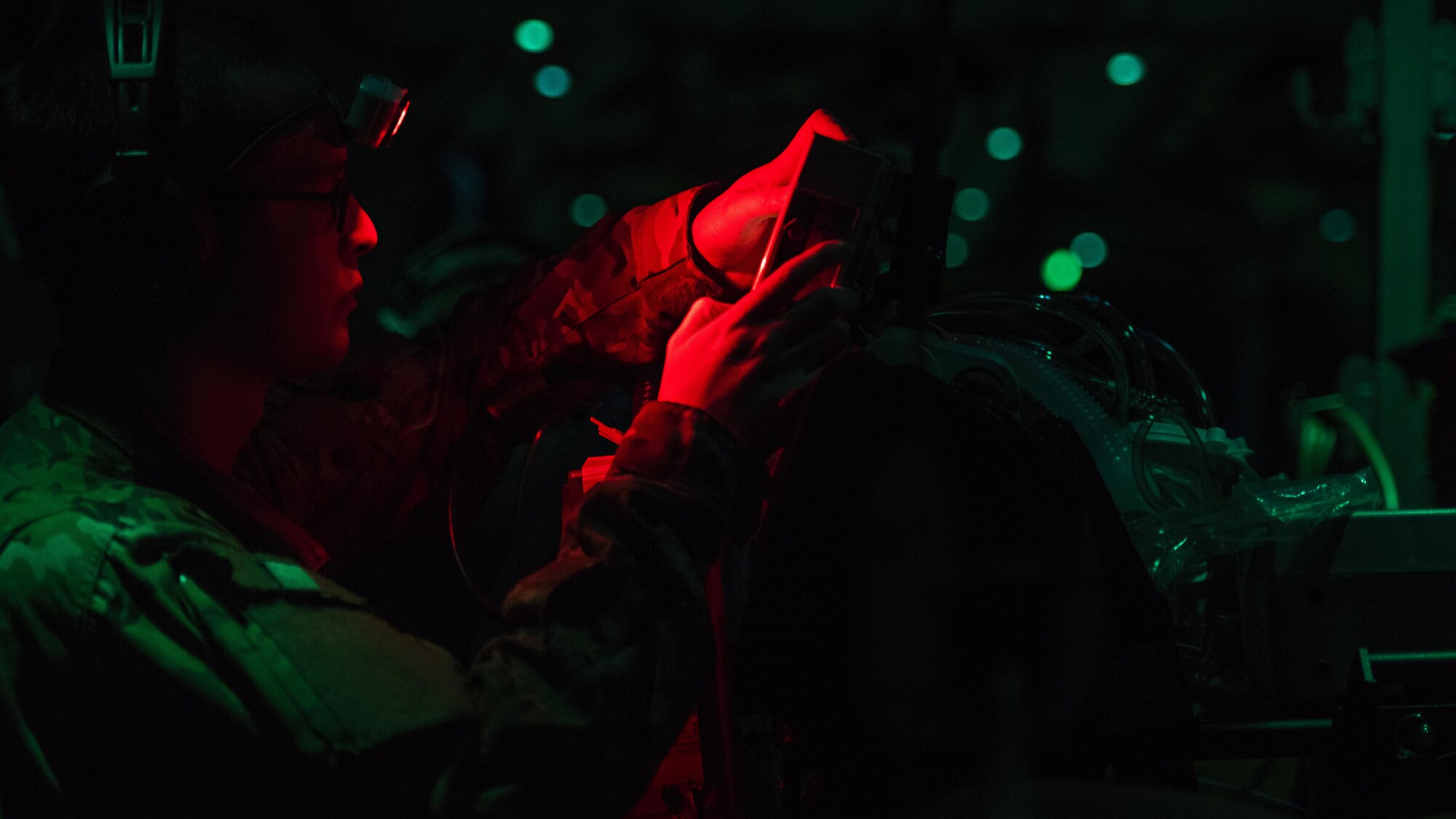 Capt. Shawn Lawson, 455th Expeditionary Aeromedical Evacuation Squadron Critical Care Air Transport Team nurse, adjusts a respirator aboard a C-130J Hercules while transporting a patient from Kandahar Airfield to Bagram Airfield, Afghanistan, Feb. 22, 2017. The patient was an Afghan National Army soldier who suffered injuries during a battle. The CCATT brought him to the Craig Joint Theater Hospital at Bagram Airfield, Afghanistan to receive treatment. (U.S. Air Force photo by Staff Sgt. Katherine Spessa)