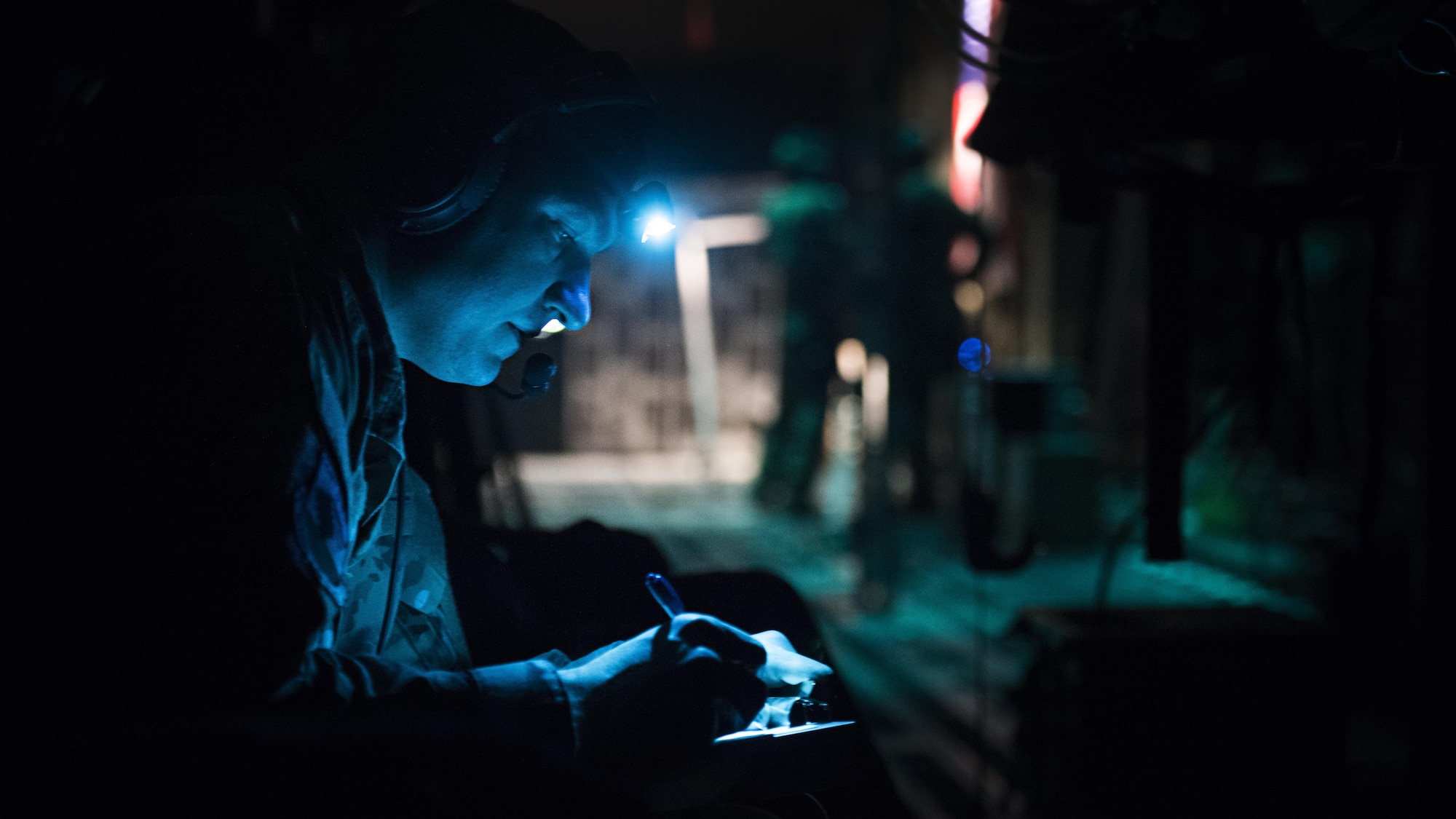 Capt. Alex Bedard, 455th Expeditionary Aeromedical Evacuation Squadron Critical Care Air Transport Team doctor, takes notes aboard a C-130J Hercules while transporting a patient from Kandahar Airfield to Bagram Airfield, Afghanistan, Feb. 22, 2017. Members of the 455th EAES transport critically ill or injured patients from austere locations throughout Afghanistan to receive a higher level of care. (U.S. Air Force photo by Staff Sgt. Katherine Spessa)