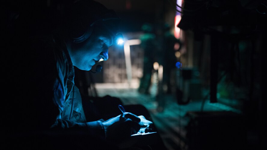 Capt. Alex Bedard, 455th Expeditionary Aeromedical Evacuation Squadron Critical Care Air Transport Team doctor, takes notes aboard a C-130J Hercules while transporting a patient from Kandahar Airfield to Bagram Airfield, Afghanistan, Feb. 22, 2017. Members of the 455th EAES transport critically ill or injured patients from austere locations throughout Afghanistan to receive a higher level of care. (U.S. Air Force photo by Staff Sgt. Katherine Spessa)