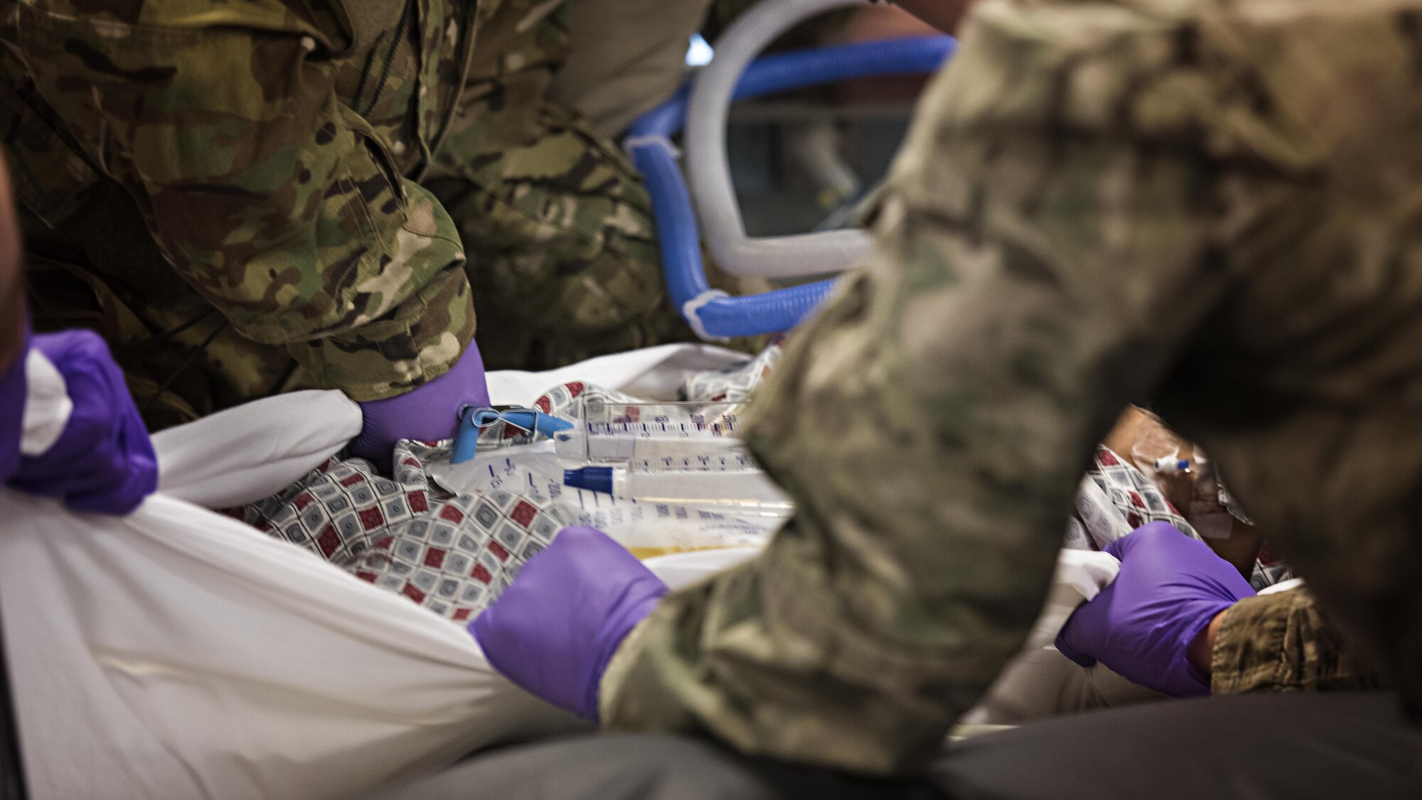 Members of the 455th Expeditionary Aeromedical Evacuation Squadron Critical Care Air Transport Team move a patient onto a litter at the Kandahar Regional Military Hospital, Kandahar Airfield, Afghanistan Feb. 22, 2017. CCATTs are made up of a doctor, a nurse and a respiratory therapist who provide in-flight medical care to critically injured or ill patients. (U.S. Air Force photo by Staff Sgt. Katherine Spessa)