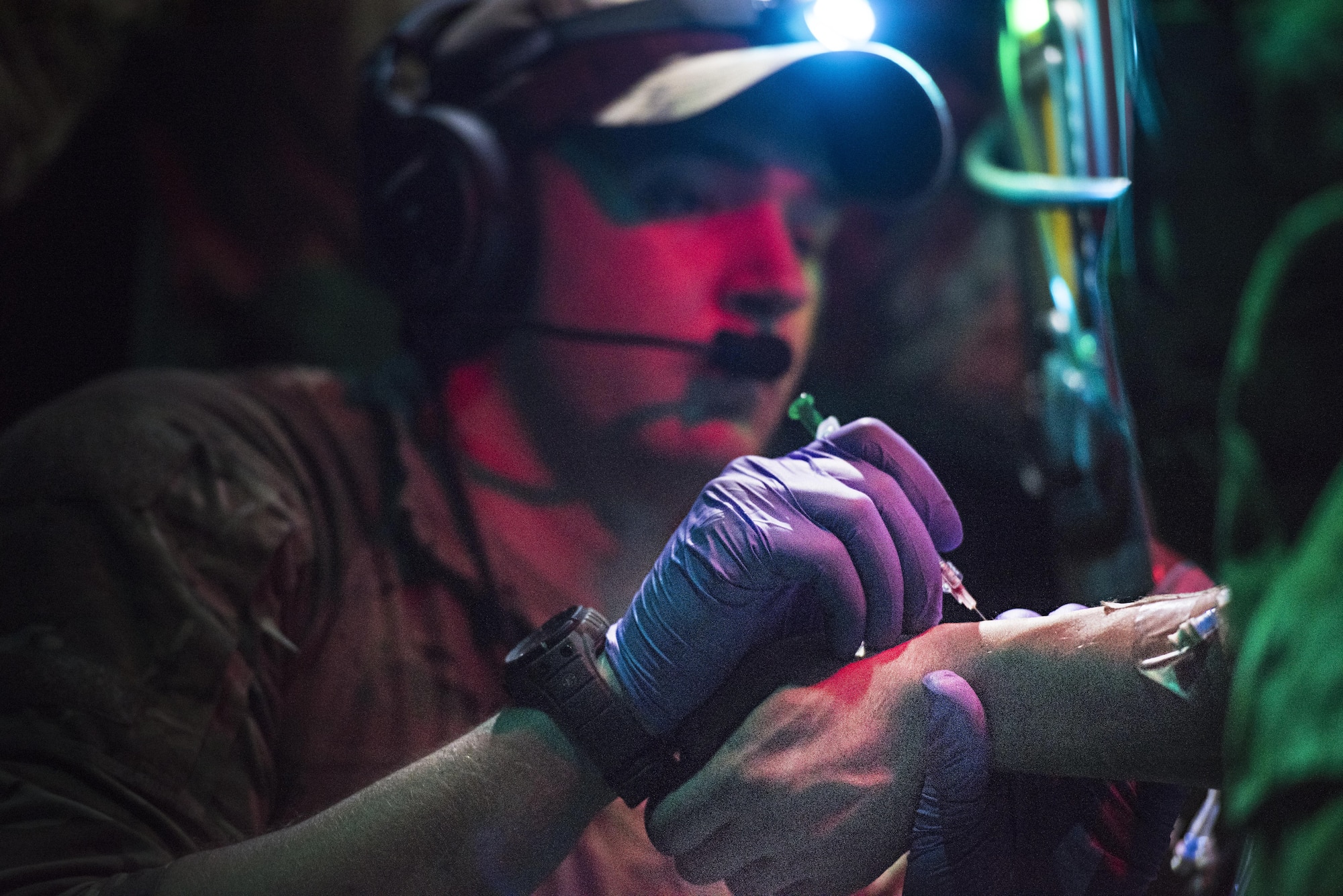 Senior Airman Joshua O’Sullivan, 455th Expeditionary Aeromedical Evacuation Squadron respiratory therapist, administers medicine to a critically injured patient being transported via C-130J Hercules for aeromedical evacuation from Kandahar Regional Military Hospital, Kandahar Airfield to the Craig Joint Theater Hospital, Bagram Airfield, Afghanistan, Feb. 22, 2017. The 455th EAES creates and operates a portable intensive care unit aboard aircraft that enables them to transport critically injured or ill patients to a higher level of care. (U.S. Air Force photo by Staff Sgt. Katherine Spessa)