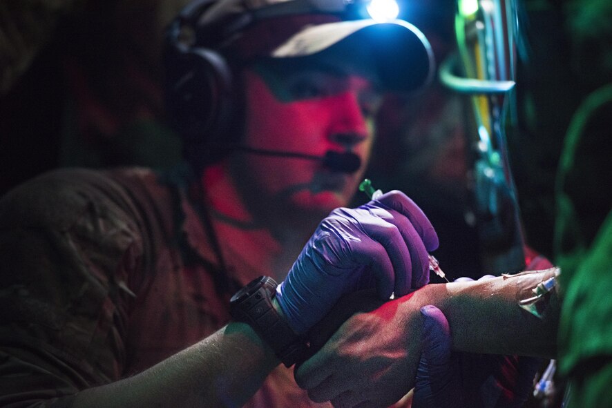 Senior Airman Joshua O’Sullivan, 455th Expeditionary Aeromedical Evacuation Squadron respiratory therapist, administers medicine to a critically injured patient being transported via C-130J Hercules for aeromedical evacuation from Kandahar Regional Military Hospital, Kandahar Airfield to the Craig Joint Theater Hospital, Bagram Airfield, Afghanistan, Feb. 22, 2017. The 455th EAES creates and operates a portable intensive care unit aboard aircraft that enables them to transport critically injured or ill patients to a higher level of care. (U.S. Air Force photo by Staff Sgt. Katherine Spessa)