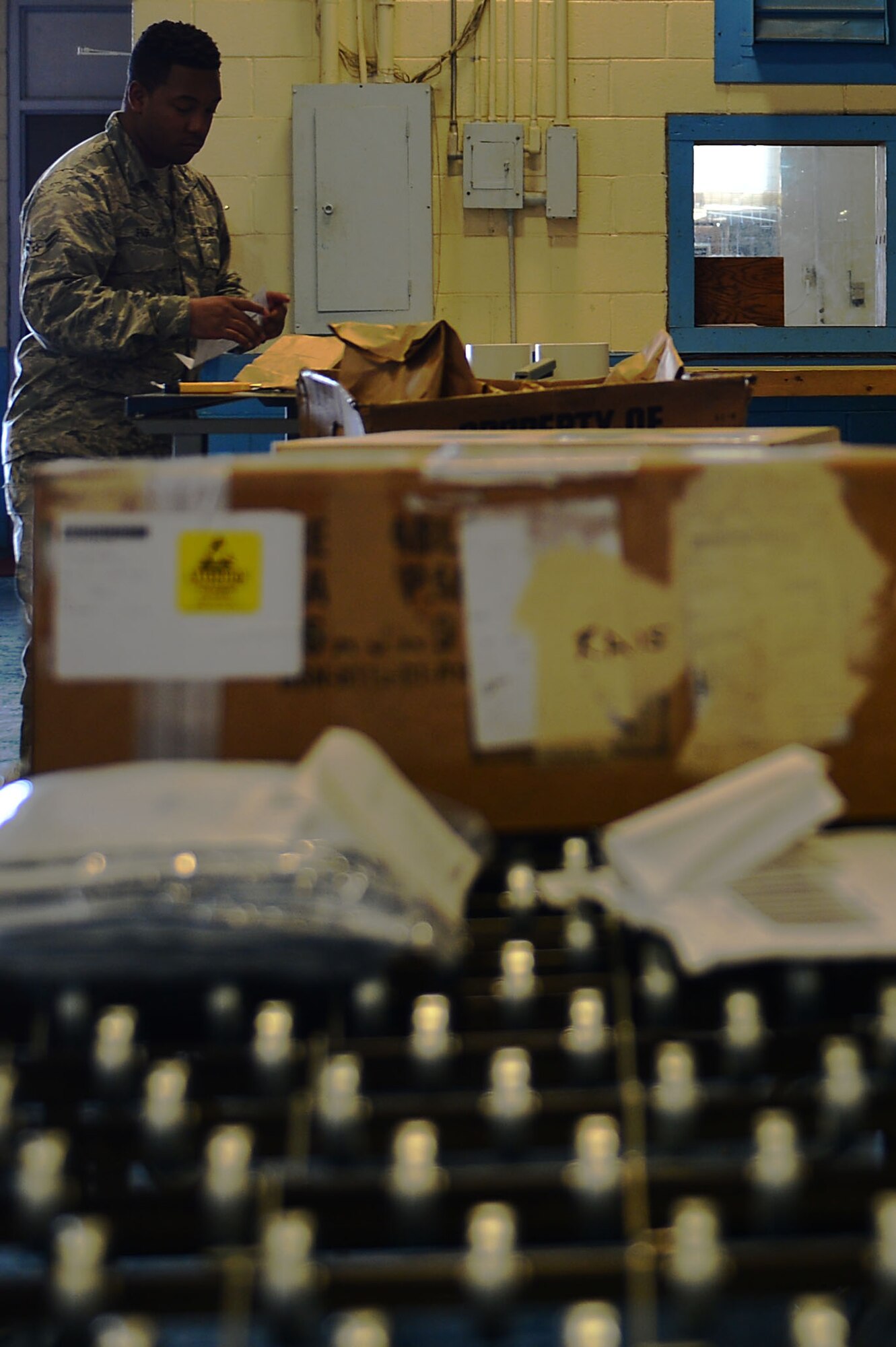 U.S. Air Force Airman 1st Class Rahkeem Fair, 20th Logistics Readiness Squadron inbound cargo journeyman, sends packages down a conveyor belt at Shaw Air Force Base, S.C., March 1, 2017. Inbound cargo receives all base shipments and transports them to their respective facilities. (U.S. Air Force photo by Airman 1st Class Christopher Maldonado)