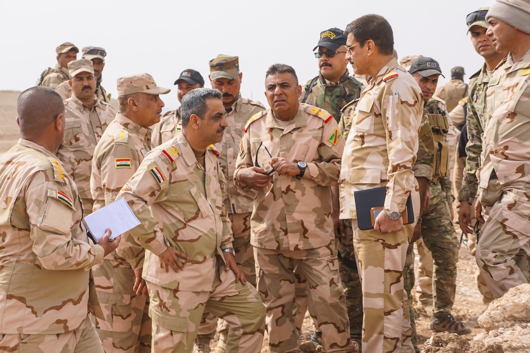 The Commanding General of the 9th Iraqi Army Division Lt. Gen. Qasim Maliki (center) confers with the Commanding General of Iraqi security forces in Ninevah Province Lt. Gen. Abdul Amir (second from right) at Al Asthana Ridge, Feb. 27, 2017.  The 9th IAD is partnered with U.S. Army 2nd Battalion, 508th Parachute Infantry Regiment, 2nd Brigade Combat Team, 82nd Airborne Division.  The 2nd BCT, 82nd Abn. Div. is deployed in support of Operation Inherent Resolve, to enable their Iraqi security forces partners through the advise and assist mission, contributing planning, intelligence collection and analysis, force protection, and precision fires to achieve the military defeat of ISIS.  CJTF-OIR is the global Coalition to defeat ISIS in Iraq and Syria. (U.S. Marine Corps photo by Capt. Timothy Irish)
