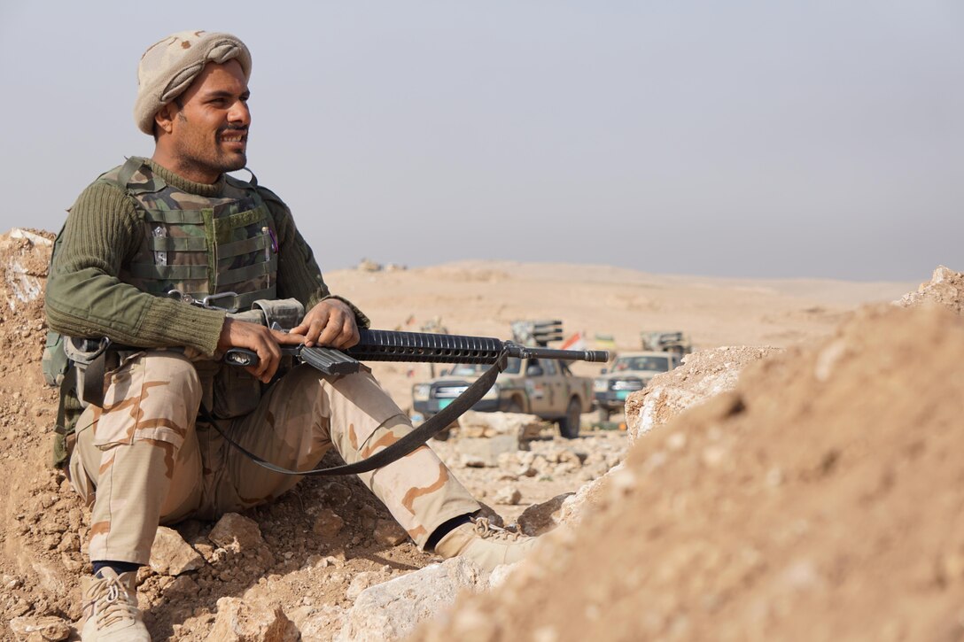 An Iraqi army soldier from 9th Iraqi Army Division sits at Al Asthana Ridge, Feb. 27, 2017. The 9th IAD is partnered with U.S. Army 2nd Battalion, 508th Parachute Infantry Regiment, 2nd Brigade Combat Team, 82nd Airborne Division. The 2nd BCT, 82nd Abn. Div. is deployed in support of Operation Inherent Resolve, to enable their Iraqi security forces partners through the advise and assist mission, contributing planning, intelligence collection and analysis, force protection, and precision fires to achieve the military defeat of ISIS.  CJTF-OIR is the global Coalition to defeat ISIS in Iraq and Syria. (U.S. Marine Corps photo by Capt. Timothy Irish)