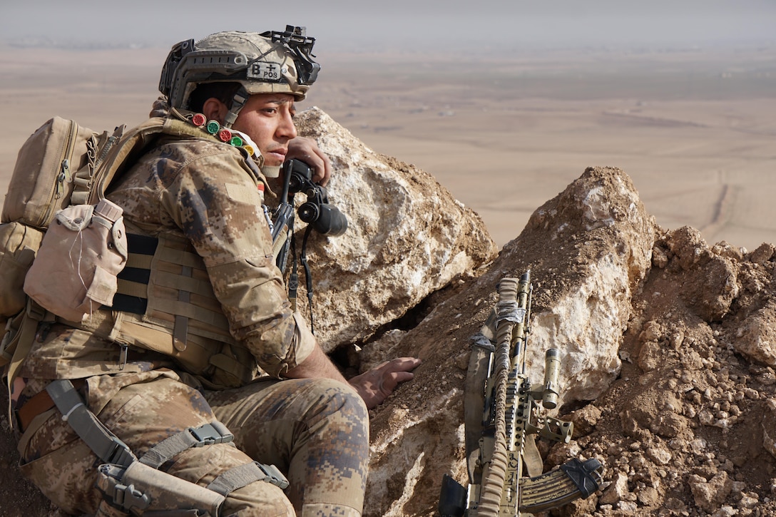 An Iraqi army soldier from 9th Iraqi Army Division sits at Al Asthana Ridge, Feb. 27, 2017.  The 9th IAD is partnered with U.S. Army 2nd Battalion, 508th Parachute Infantry Regiment, 2nd Brigade Combat Team, 82nd Airborne Division. The 2nd BCT, 82nd Abn. Div. is deployed in support of Operation Inherent Resolve, to enable their Iraqi security forces partners through the advise and assist mission, contributing planning, intelligence collection and analysis, force protection, and precision fires to achieve the military defeat of ISIS.  CJTF-OIR is the global Coalition to defeat ISIS in Iraq and Syria. (U.S. Marine Corps photo by Capt. Timothy Irish)