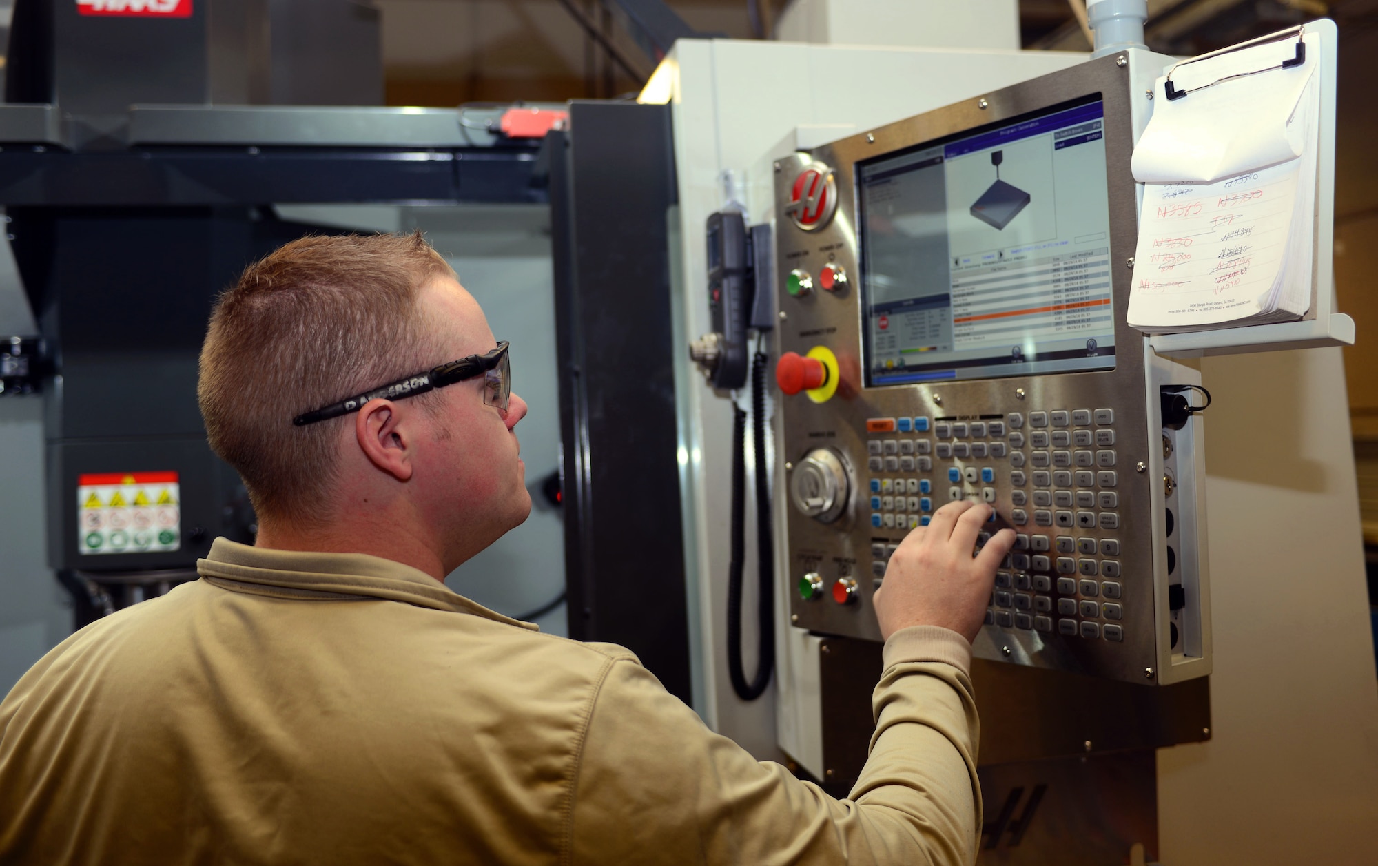 Senior Airman Drake Anderson, an aircraft metals technology journeyman assigned to the 28th Maintenance Squadron, inputs instructions into a VF5 Super Speed at Ellsworth Air Force Base, S.D., Feb. 22, 2017. The Super-Speed Vertical Machining Center, or the VF-5SS, allows the shop to speed up the manufacturing process and run more efficiently, as well as provides a way to test the tolerance of new aircraft parts. (U.S. Air Force photo by Airman 1st Class Donald C. Knechtel)