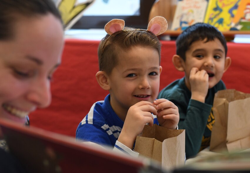 An elementary school student listens to a story being read during the Seuss Reading Café at Ramstein Air Base, Germany, March 3, 2017.  The week-long event aims to recognize Dr. Seuss’ birthday by promoting reading. (U.S. Air Force photo by Staff Sgt. Nesha Humes)