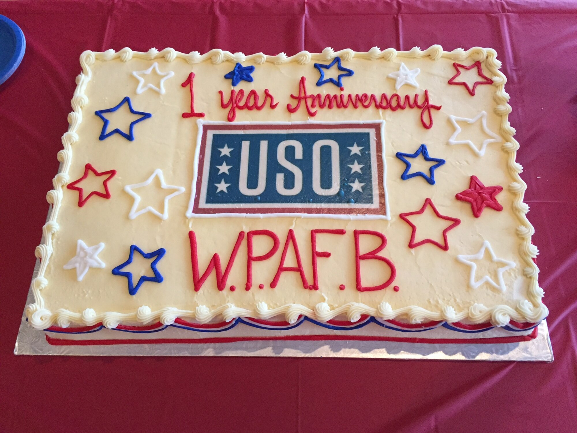 USO Community Center volunteers, donors and Team Wright-Patt members enjoy refreshments, including a cake, during the center’s first anniversary Feb. 24. (Skywrighter photo/Amy Rollins)