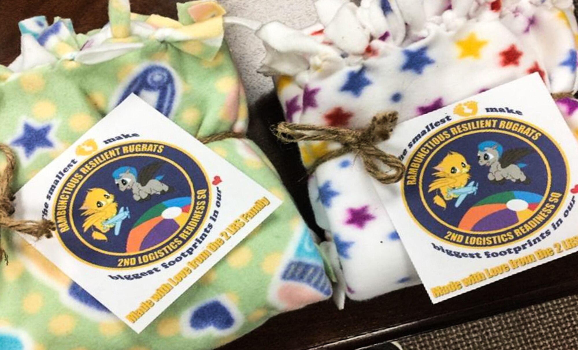 Baby blankets crafted by key spouses from the 2nd Logistics Readiness Squadron are displayed during an even at Barksdale Air Force Base, La., Feb. 7, 2017. The key spouses created 43 blankets to be presented during commander’s calls to families with new-born babies. (Courtesy Photo)