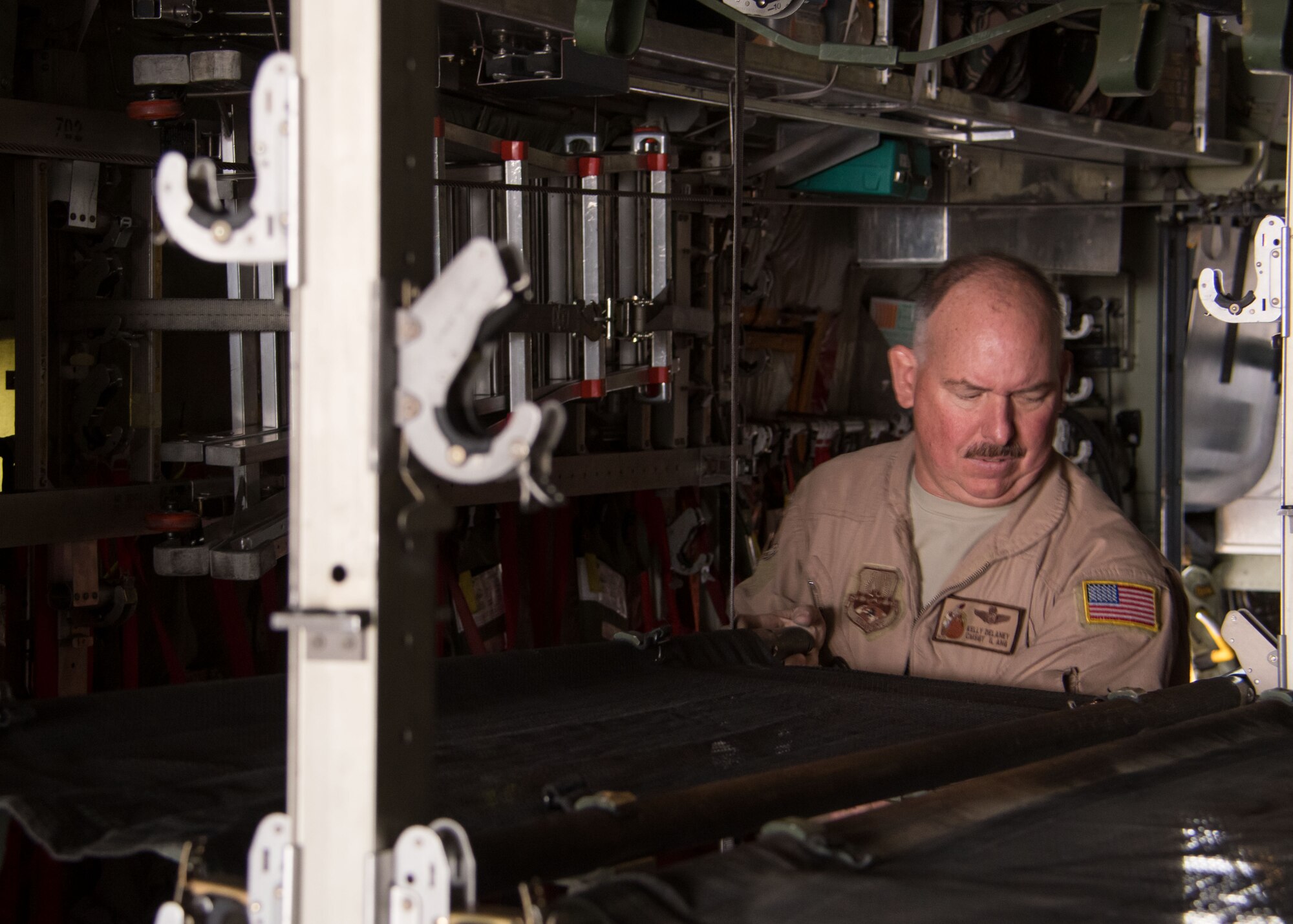 Chief Master Sgt. Kelly Delaney, a 737th Expeditionary Airlift Squadron loadmaster, installs a litter in the back of a C-130H Hercules at an undisclosed location in Southwest Asia March 3, 2017. Delaney is currently on his ninth deployment to the U.S. Air Forces Central Command area of responsibility. (U.S. Air Force photo/Senior Airman Andrew Park)