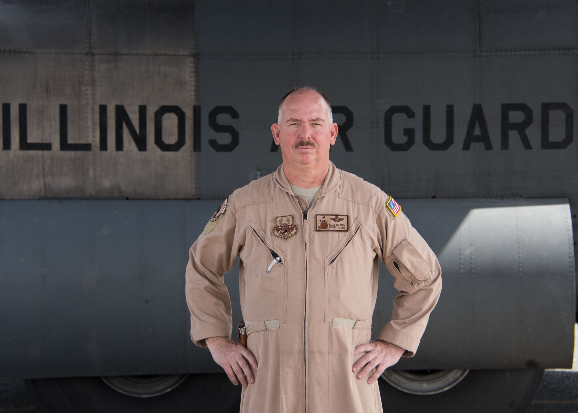 Chief Master Sgt. Kelly Delaney, a 737th Expeditionary Airlift Squadron loadmaster, poses for a photo in front of a C-130H Hercules at an undisclosed location in Southwest Asia March 3, 2017. Delaney is deployed from the Illinois Air National Guard. (U.S. Air Force photo/Senior Airman Andrew Park)