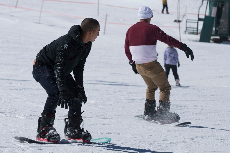 Pfc. Dante Garza and Lance Cpl. Omar Irizarry, riflemen, 2nd Battalion, 7th Marine Regiment, practice snowboarding during a trip to Bear Mountain Ski Resort in Big Bear Lake, Feb. 23, 2017. The trip was provided to the unit courtesy of Operation Adrenaline Rush, a program aimed toward reintegrating Marines and sailors who have just come home from deployment. (U.S Marine photo by Cpl. Medina Ayala-Lo)