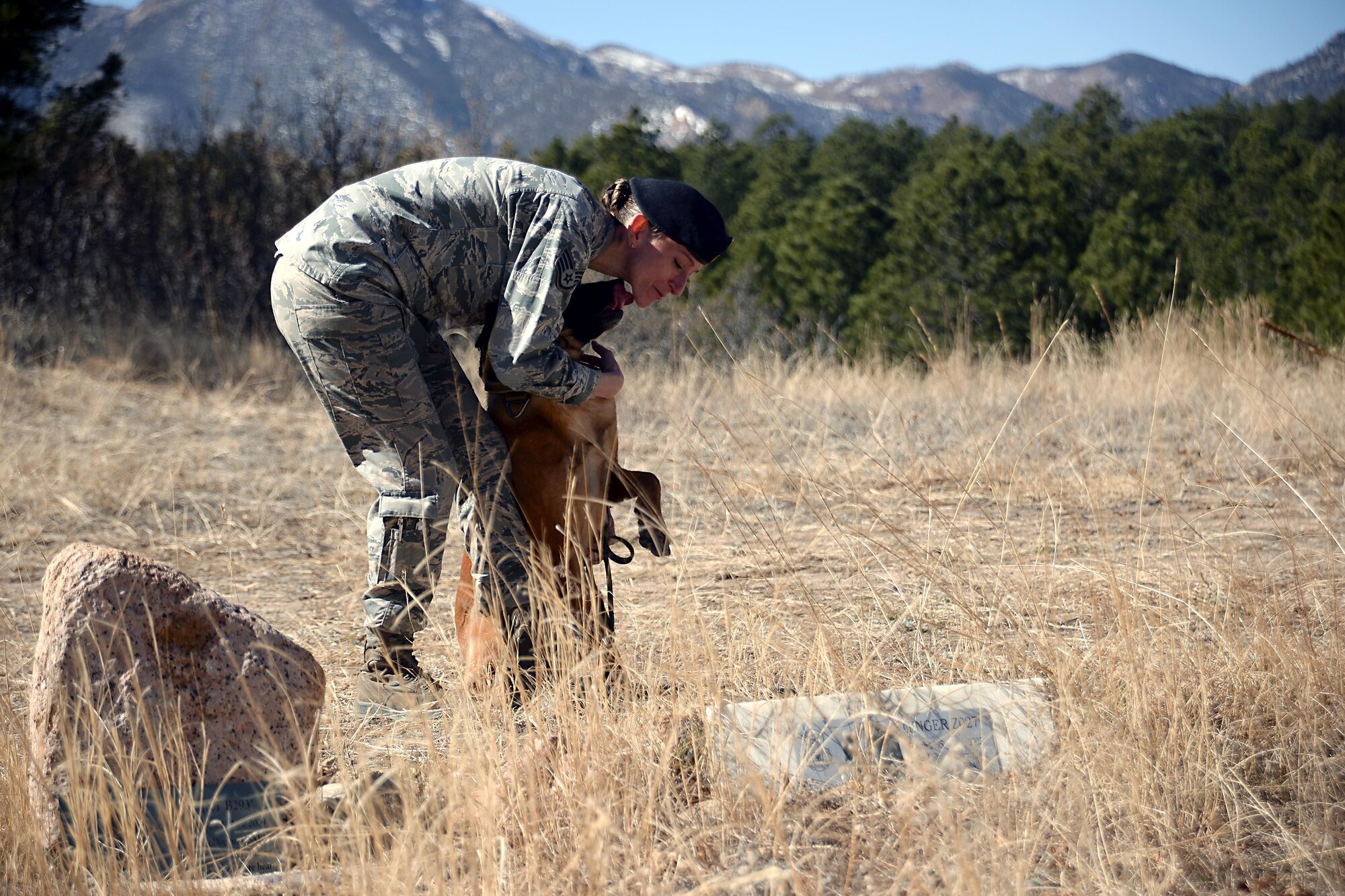 Staff Sgt. Melissa Burns, the Military Working Dog trainer for the
10th Security Forces Squadron, holds "Rruuk," a military working dog assigned to the squadron, March 2, 2017, at the MWD Memorial Grounds at the U.S. Air Force Academy.  (U.S. Air Force photo/Darcie Ibidapo)
