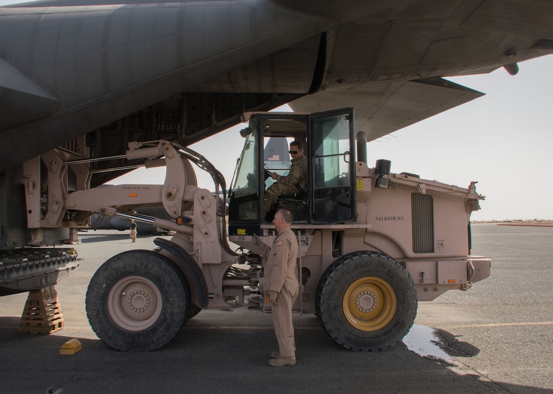 Chief Master Sgt. Kelly Delaney, a 737th Expeditionary Airlift Squadron loadmaster, helps guide a forklift as it loads a pallet onto a C-130H Hercules at an undisclosed location in Southwest Asia March 3, 2017. Throughout his 36-year career, Delaney has worked on a variety of C-130 models. (U.S. Air Force photo/Senior Airman Andrew Park)