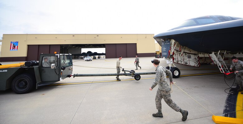 Crew chiefs assigned to the 509th and 131st Aircraft Maintenance Squadrons prepare to tow a B-2 Spirit into its dock during a no-notice operational readiness exercise at Whiteman Air Force Base, Mo., Feb. 28, 2017. During the exercise, Airmen were tasked with executing procedures and operations to validate Whiteman’s strategic deterrence and operational readiness.