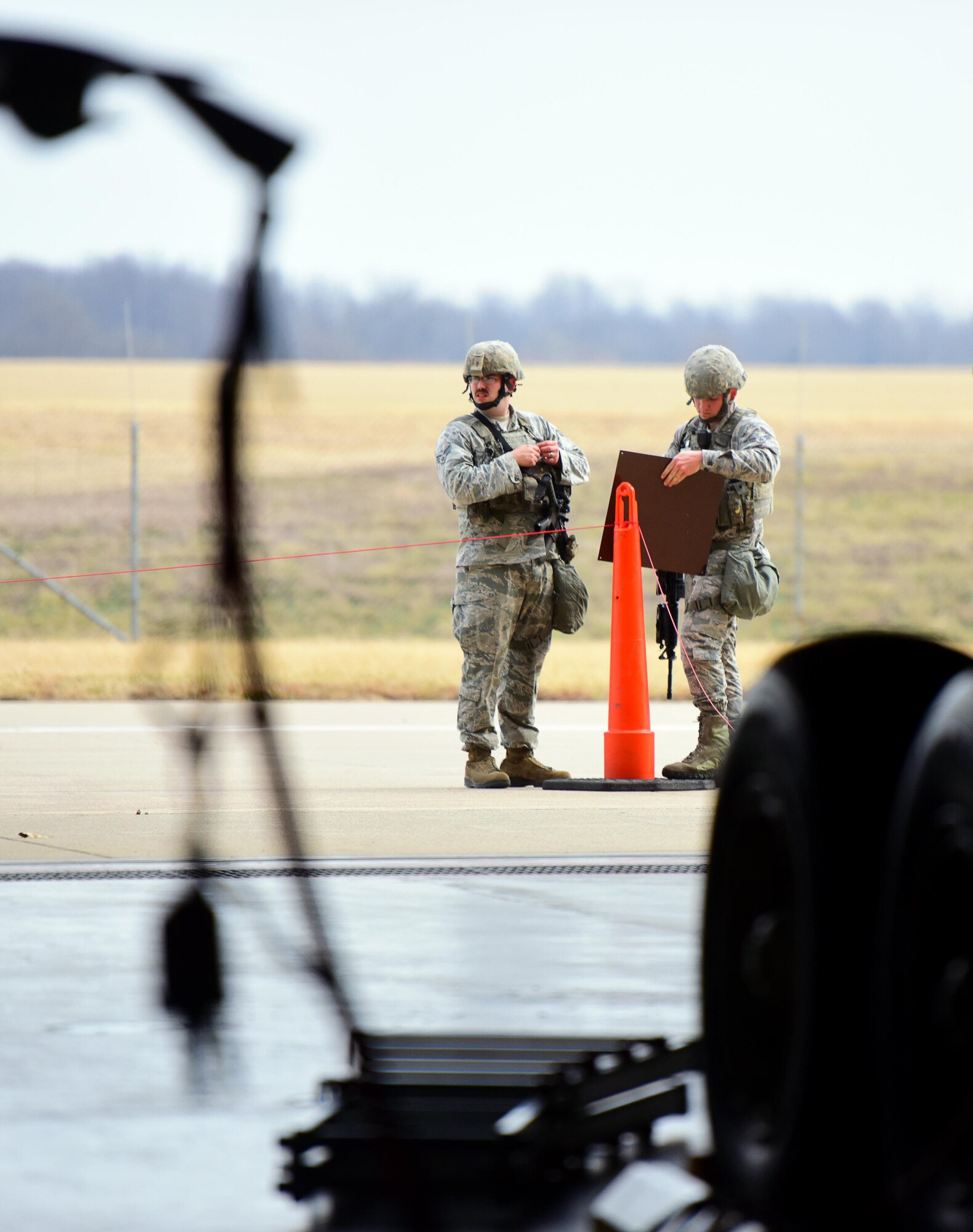 U.S. Air Force Airman 1st Class Eric Burns and Senior Airman Joseph Gaffney, both security response team members assigned to the 509th Security Forces Squadron (SFS), extend the exclusion area to ensure proper safety of resources at Whiteman Air Force Base, Mo., Feb. 28, 2017, in support of a no-notice operational readiness exercise. During the exercise, SFS Airmen validated Whiteman’s force protection procedures.