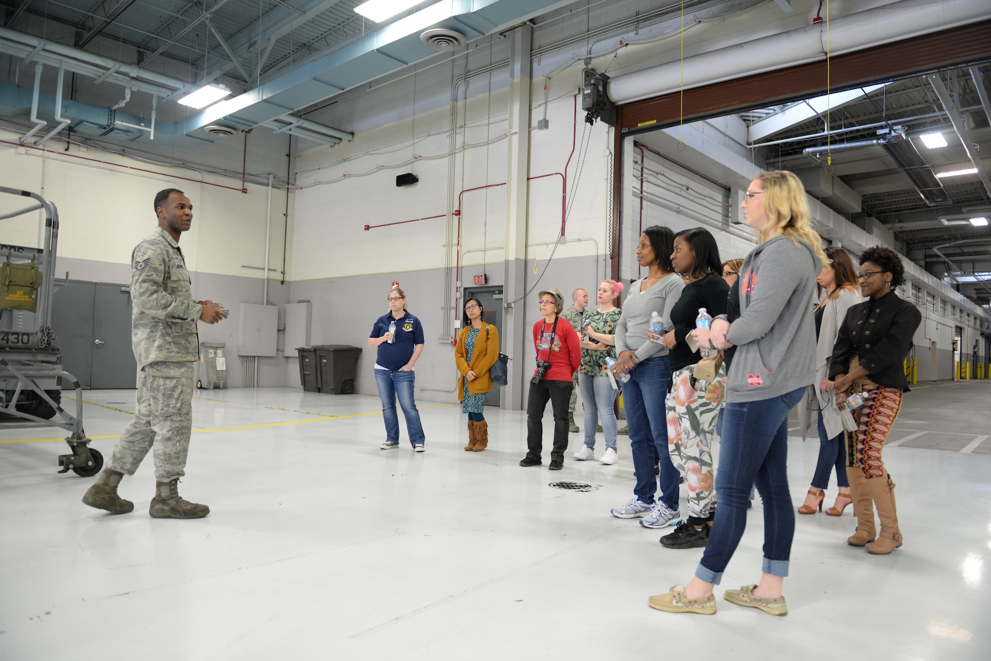 Staff Sgt. Andrew Scipio, 55th Maintenance Squadron aerospace ground equipment craftsman, gives a tour of the AGE shop to 55th MXS spouses in the Bennie L. Davis Maintenance Facility at Offutt Air Force Base, Neb., Feb. 17, 2017. Members of the 55th MXS had a chance to show their spouses what they do for the Air Force.(U.S. Air Force photo by Zachary Hada)