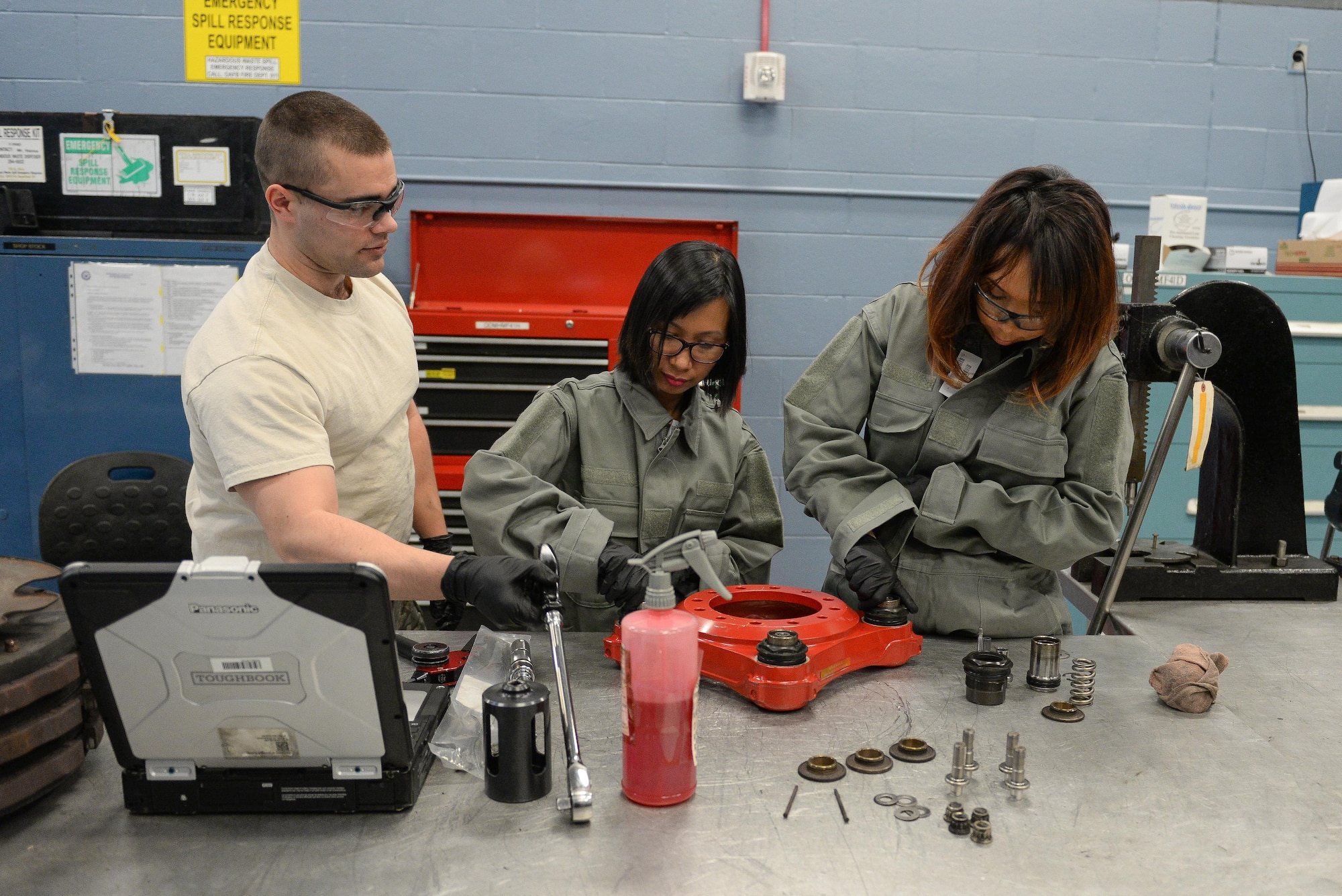 Airman 1st Class Kameron Hamilton, 55th Maintenance Squadron hydraulics system journeyman, shows 55th MXS spouses how to work on an RC-135 break assembly part in the Bennie L. Davis Maintenance Facility at Offutt Air Force Base, Neb., Feb. 17, 2017. The tour began with a briefing followed by a tour of all the shops in the maintenance facility and ended with an aircraft tour. (U.S. Air Force photo by Zachary Hada)