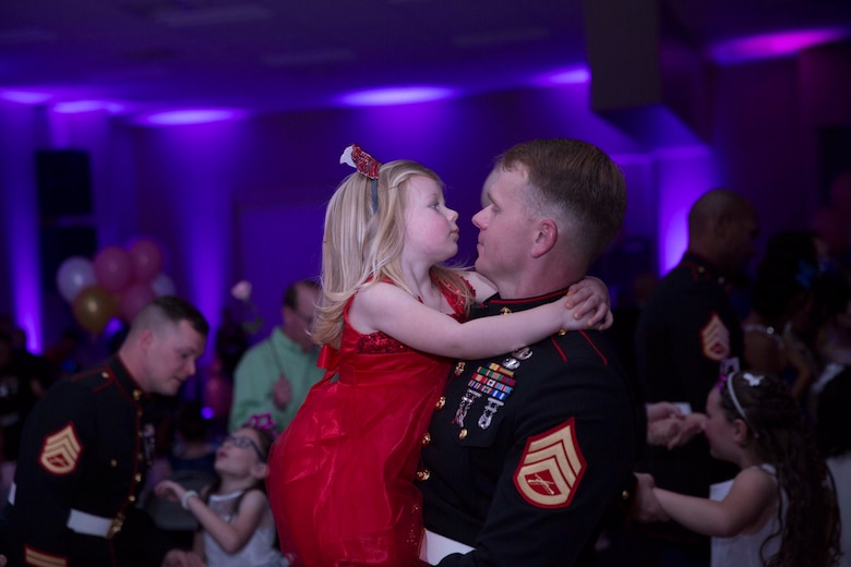 Staff Sgt. Robert A. Bouchard, EOD Technician, holds his daughter, Tenley, 3, as they dance during the annual Father Daughter Dance at building 1707 aboard Marine Corps Air Ground Combat Center, Twentynine Palms, Calif., Feb. 25, 2017. Marine Corps Community Services hosted the event to provide an opportunity for Marines and sailors to spend time with their daughters. (U.S. Marine Corps photo by Cpl. Medina Ayala-Lo)