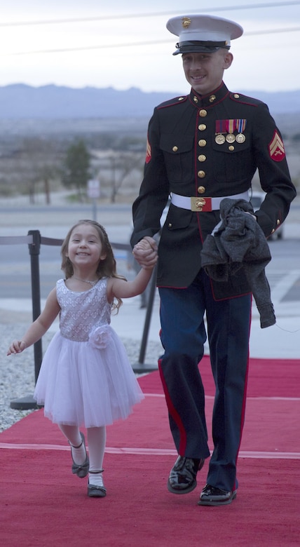 Cpl. Justin Falcon, automotive organizational mechanic, 7th Marine Regiment, escorts his daughter, Madelyn, 4, into the reception hall of the annual Father Daughter Dance at building 1707 aboard Marine Corps Air Ground Combat Center, Twentynine Palms, Calif., Feb. 25, 2017. Marine Corps Community Services hosted the event to provide an opportunity for Marines and sailors to spend time with their daughters. (U.S. Marine Corps photo by Cpl. Medina Ayala-Lo)