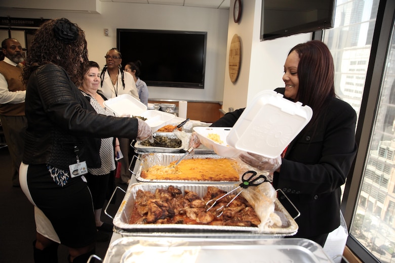 Delfina Fallin(left) and Bridgett Hollier(right) are members of the District's Black Employment Program prepared luncheon plates for district employees attending the closing observance of the Black History Month.  The U.S. Army Corps of Engineers Los Angeles District Black Employment Special Emphasis Program committee held its Black History Month observance closing ceremony at the District's headquarters Feb. 23. A “Soul food” luncheon followed the ceremony with a menu consisting of both fried and baked chicken, yams, macaroni and cheese, collard greens and an assortment of cakes and pie for dessert.