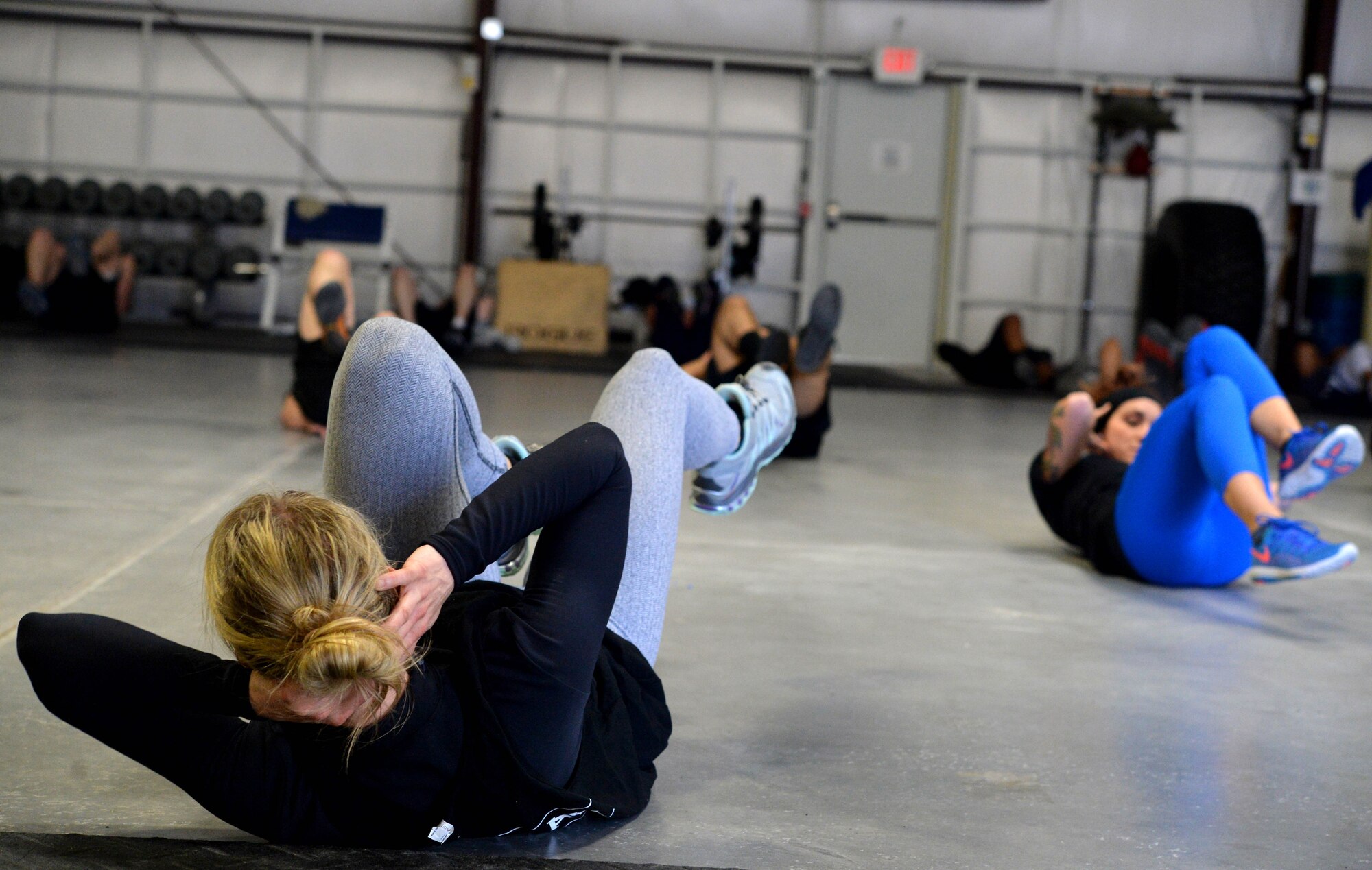 Airmen from the 432nd Wing and 799th Air Base Group participate in Life of a Warrior fitness training Feb. 24, 2017, at Creech Air Force Base, Nev. During the session, Airmen strengthened their bodies through a variety of functional exercises such as squats, push-ups, sit-ups, running and a host of other movements. (U.S. Air Force photo/Airman 1st Class Kristan Campbell)

