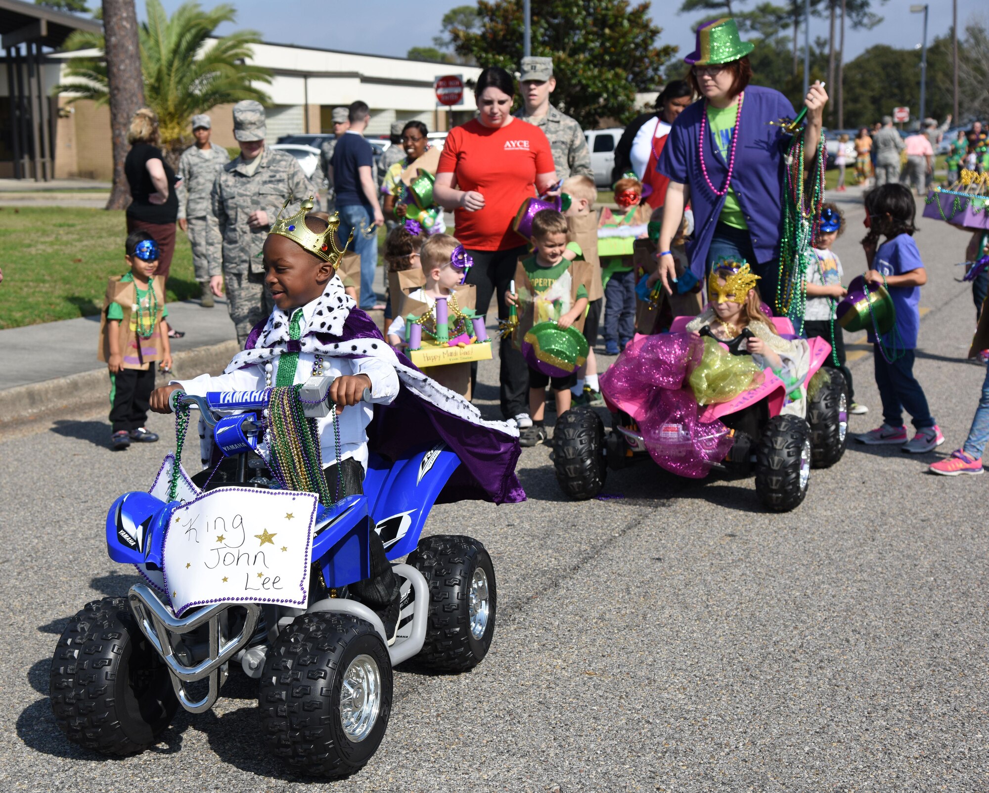 “King” John Lee, son of Suhajda Pringle, 336th Training Squadron instructor, rides his four wheeler in the Keesler Child Development Center Mardi Gras parade Feb. 28, 2017, on Keesler Air Force Base, Miss. More than 300 children participated in the event, which started in 2009. (U.S. Air Force photo by Kemberly Groue)
