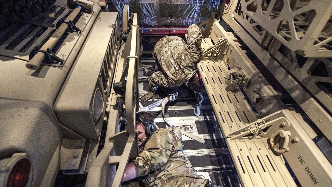 Airmen assigned to the 9th Special Operations Squadron strap down Humvees inside an MC-130J Commmando II aircraft during Emerald Warrior 17 at Hurlburt Field, Fla., Feb. 28, 2017. Air Force photo by Staff Sgt. Corey Hook