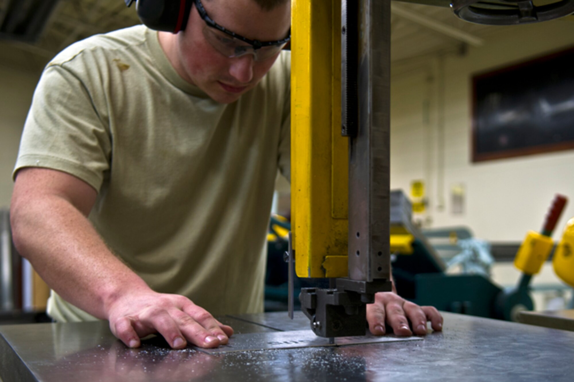 Staff Sergeant Shane Wilcox, 434th Maintenance Squadron structural repair technician, cuts a sheet of aluminum at Grissom Air Reserve Base, Ind., Feb. 22, 2017. Structural repair technicians restore and replace damaged aircraft parts, reducing the need to purchase new parts. (U.S. Air Force photo/Senior Airman Harrison Withrow)