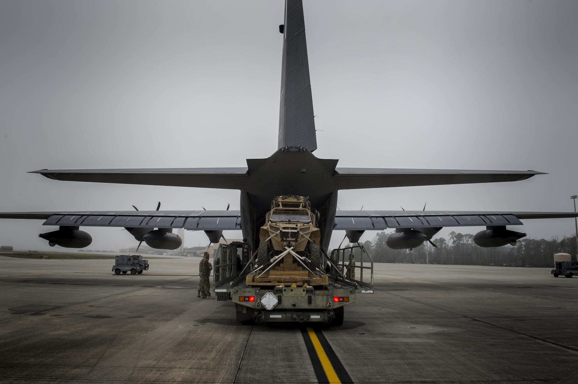 Airmen load a military RZR all-terrain vehicle into an HC-130J Combat King II, before a vehicle drop exercise, March 1, 2017, at Moody Air Force Base, Ga.  This was the first time the 38th Rescue Squadron dropped a MRZR and a significant feat as it landed on target, with no damage or discrepancies. (U.S. Air Force photo by Tech. Sgt. Zachary Wolf)
