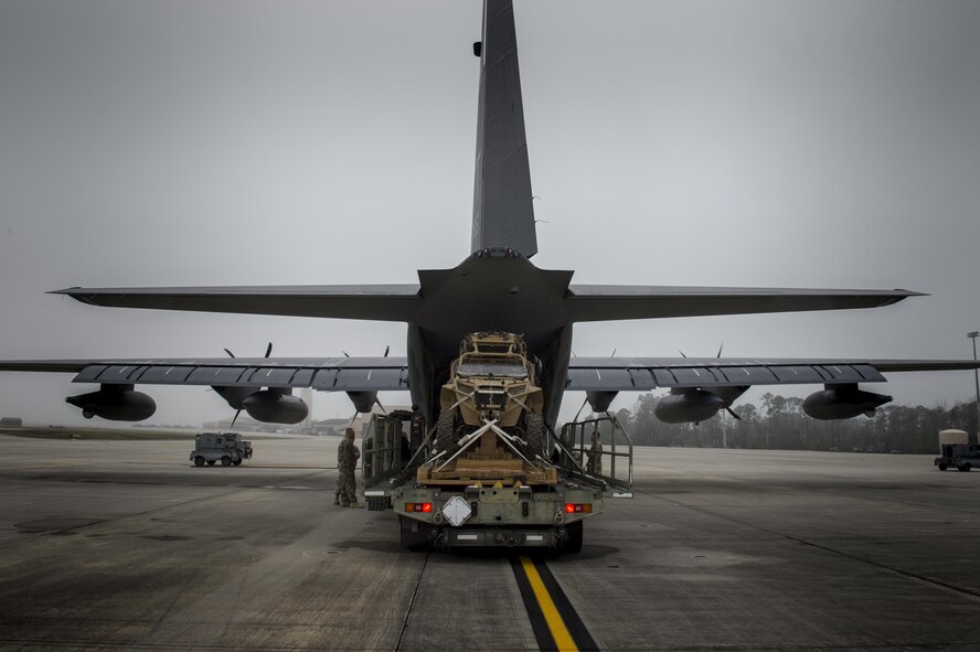 Airmen load a military RZR all-terrain vehicle into an HC-130J Combat King II, before a vehicle drop exercise, March 1, 2017, at Moody Air Force Base, Ga.  This was the first time the 38th Rescue Squadron dropped a MRZR and a significant feat as it landed on target, with no damage or discrepancies. (U.S. Air Force photo by Tech. Sgt. Zachary Wolf)
