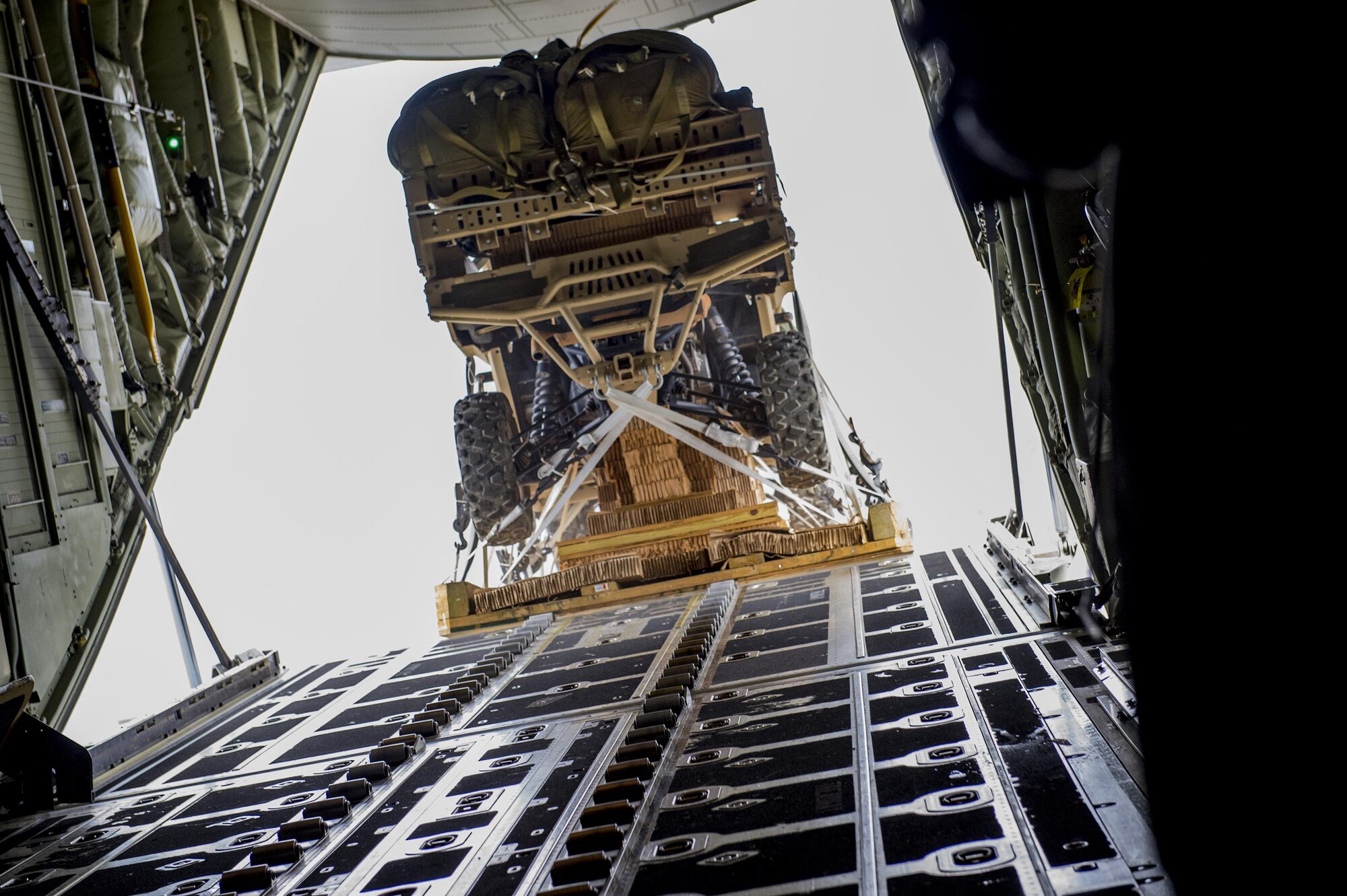 A military RZR all-terrain vehicle exits an HC-130J Combat King II, over the skies of Grand Bay Bombing and Gunnery Range during a vehicle drop exercise, March 1, 2017, at Moody Air Force Base, Ga. This was the first time the 38th Rescue Squadron dropped a MRZR and a significant feat as it landed on target, with no damage or discrepancies. (U.S. Air Force photo by Tech. Sgt. Zachary Wolf)
