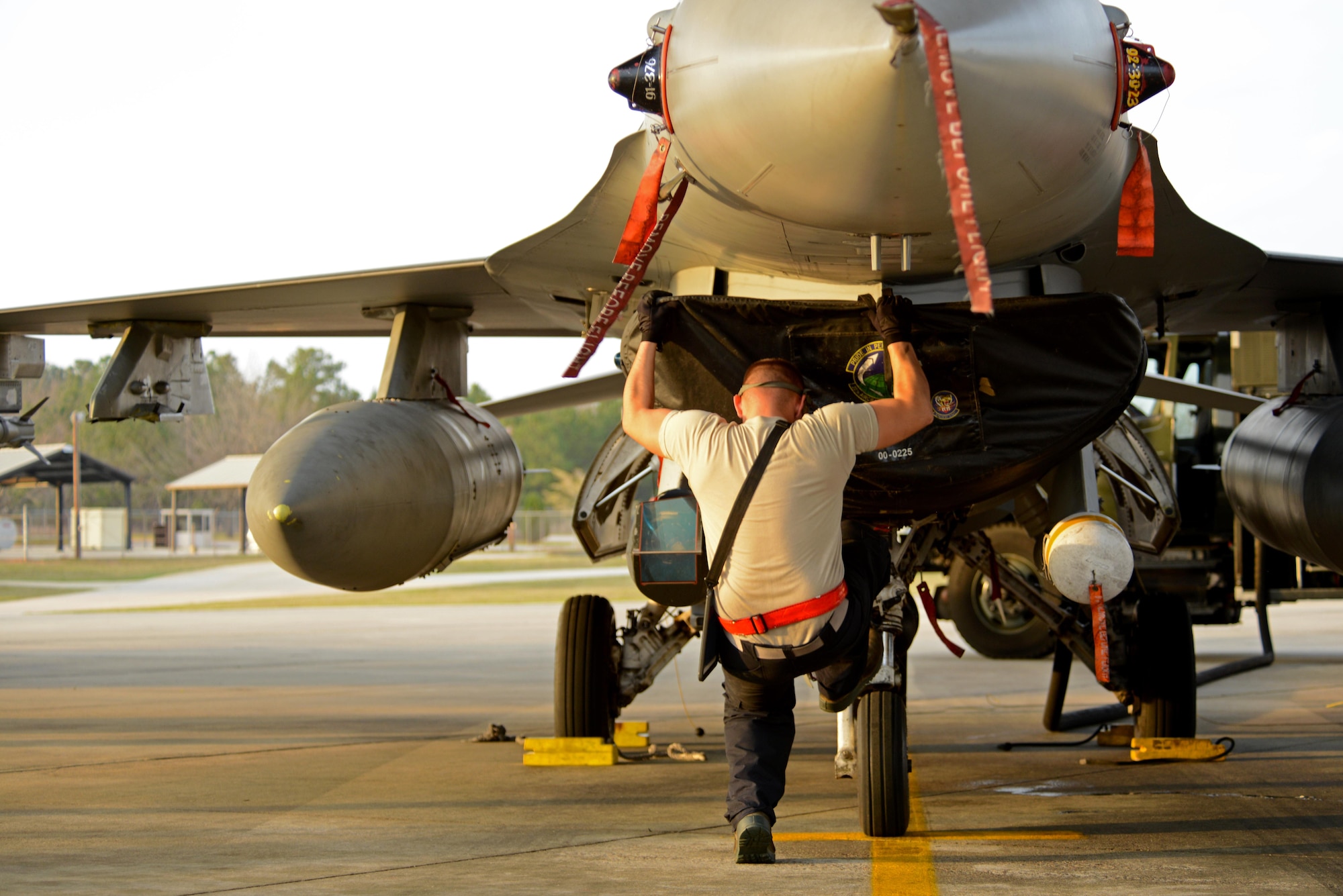 U.S. Air Force Airman 1st Class Zachary Rogers, 20th Aircraft Maintenance Squadron tactical aircraft maintainer, kicks the tire of a F-16CM Fighting Falcon while refueling at Shaw Air Force Base, S.C., Feb. 28, 2017. The tire is kicked during the refueling process to help gradually lower the nose of the aircraft, where the fuel settles. (U.S. Air Force photo by Airman 1st Class Kathryn R.C. Reaves)