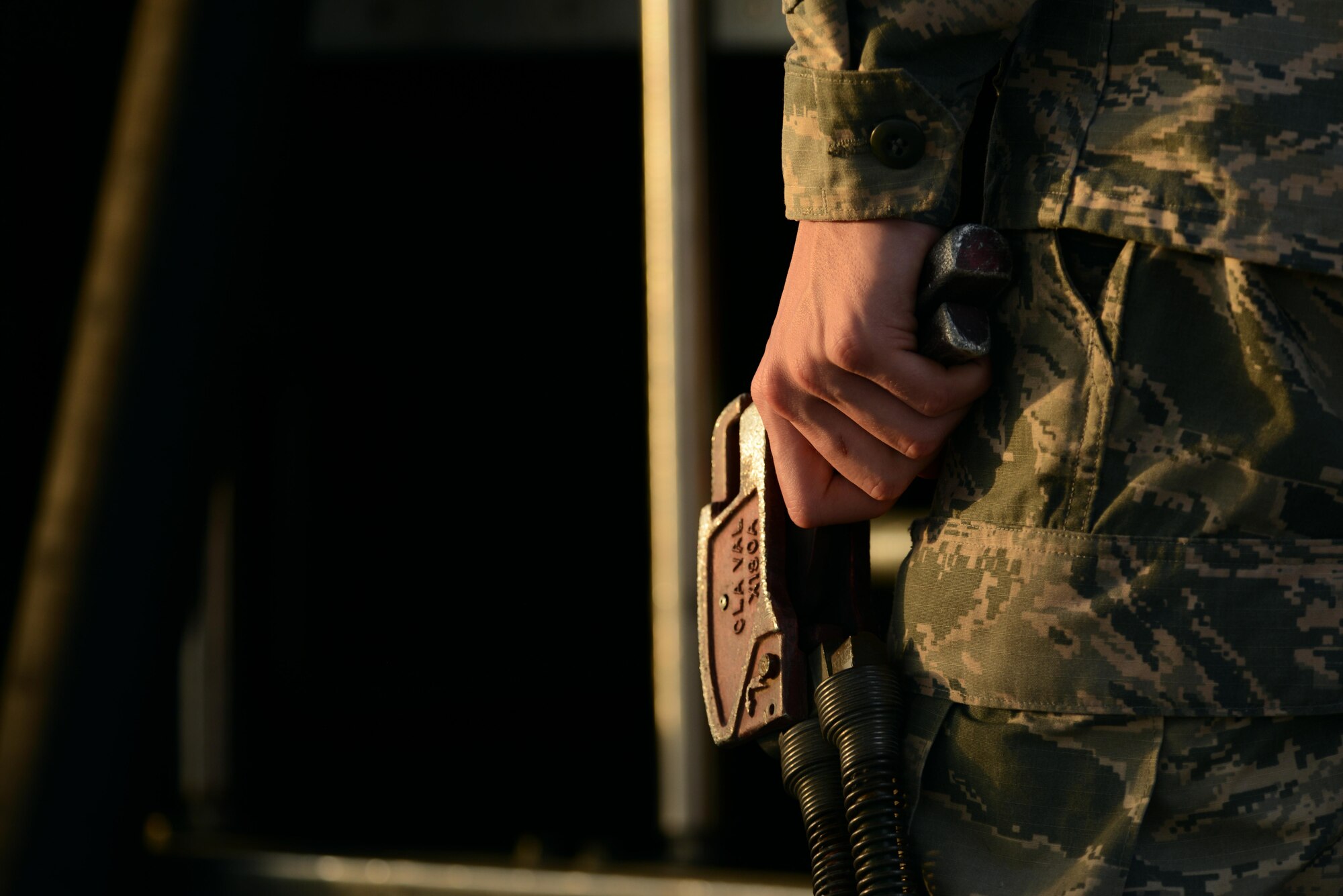 U.S. Air Force Airman 1st Class Alec Hyman, 20th Logistics Readiness Squadron fuels distribution operator, holds a fuel trigger while refueling a F-16CM Fighting Falcon at Shaw Air Force Base, S.C., Feb. 28, 2017. The trigger allows the fuels distribution operator to control the flow of Jet A fuel from an R-11 refueling truck into an aircraft. (U.S. Air Force photo by Airman 1st Class Kathryn R.C. Reaves)