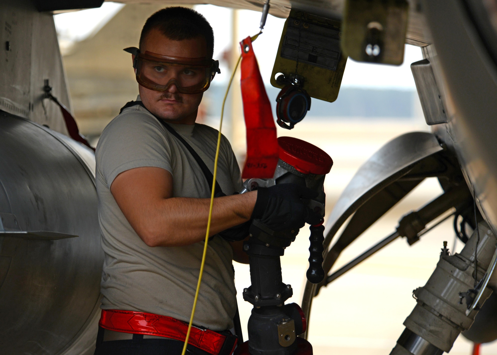 U.S. Air Force Airman 1st Class Zachary Rogers, 20th Aircraft Maintenance Squadron tactical aircraft maintainer, detaches a fuel nozzle from a F-16CM Fighting Falcon at Shaw Air Force Base, S.C., Feb. 28, 2017. The aircraft can hold approximately 1,600 gallons of Jet A fuel if equipped with external tanks.  (U.S. Air Force photo by Airman 1st Class Kathryn R.C. Reaves)